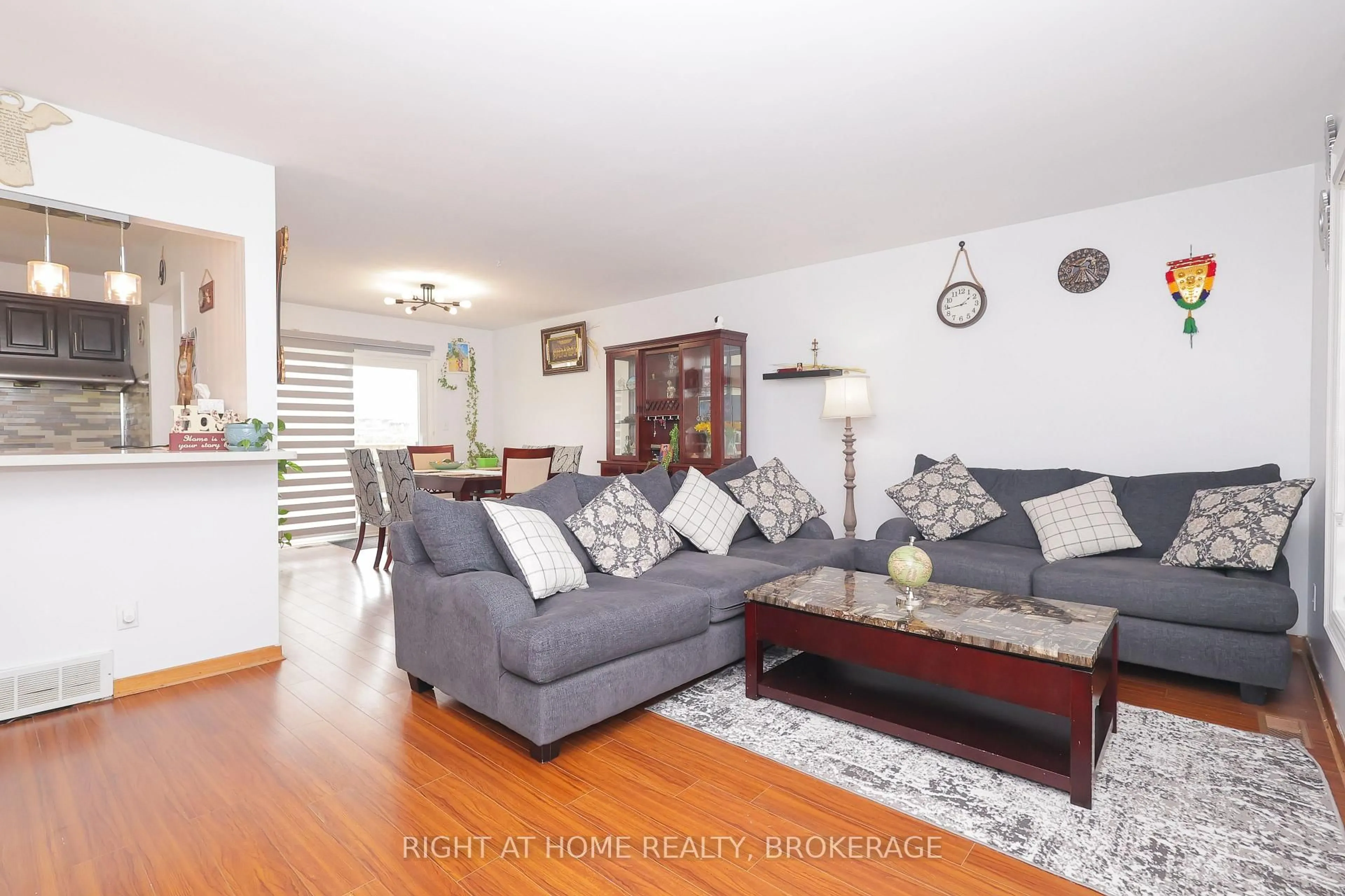 Living room with furniture, wood/laminate floor for 7698 Mulhern St, Niagara Falls Ontario L2H 1B5