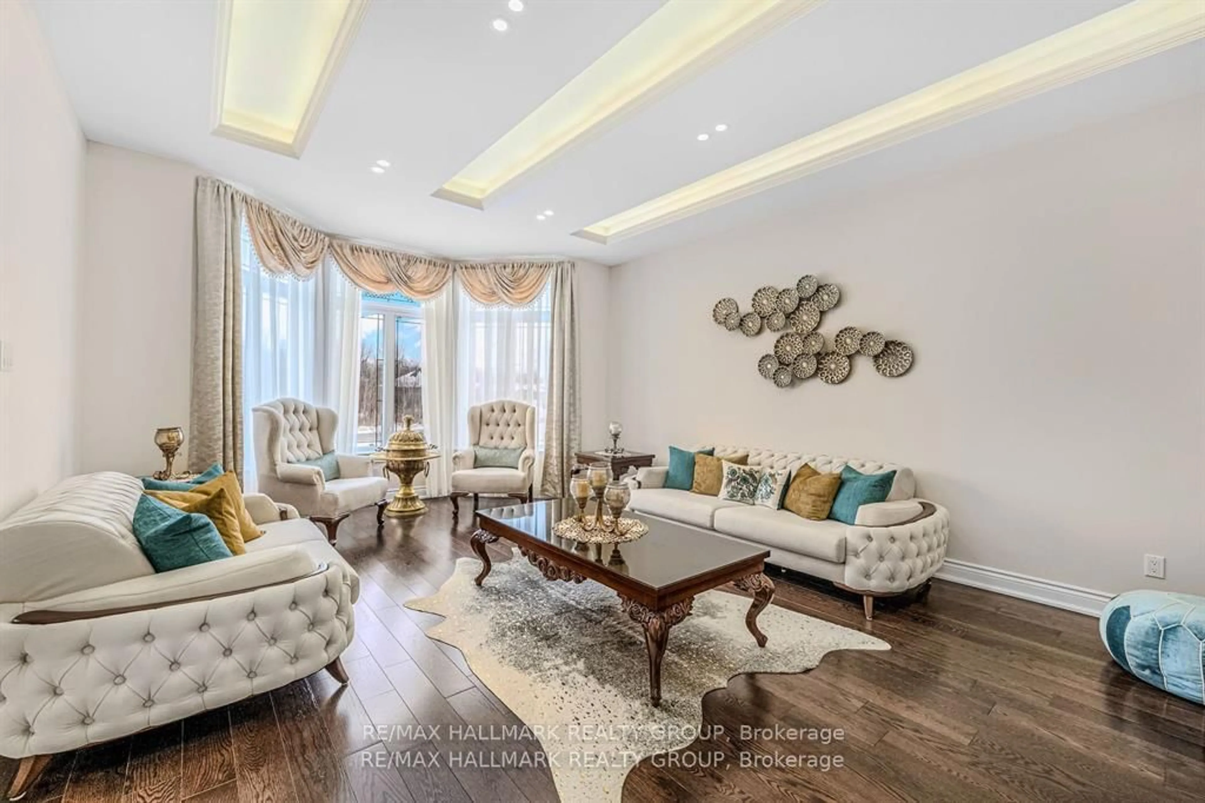 Living room with furniture, wood/laminate floor for 699 Ballycastle Cres, Ottawa Ontario K1X 0A4