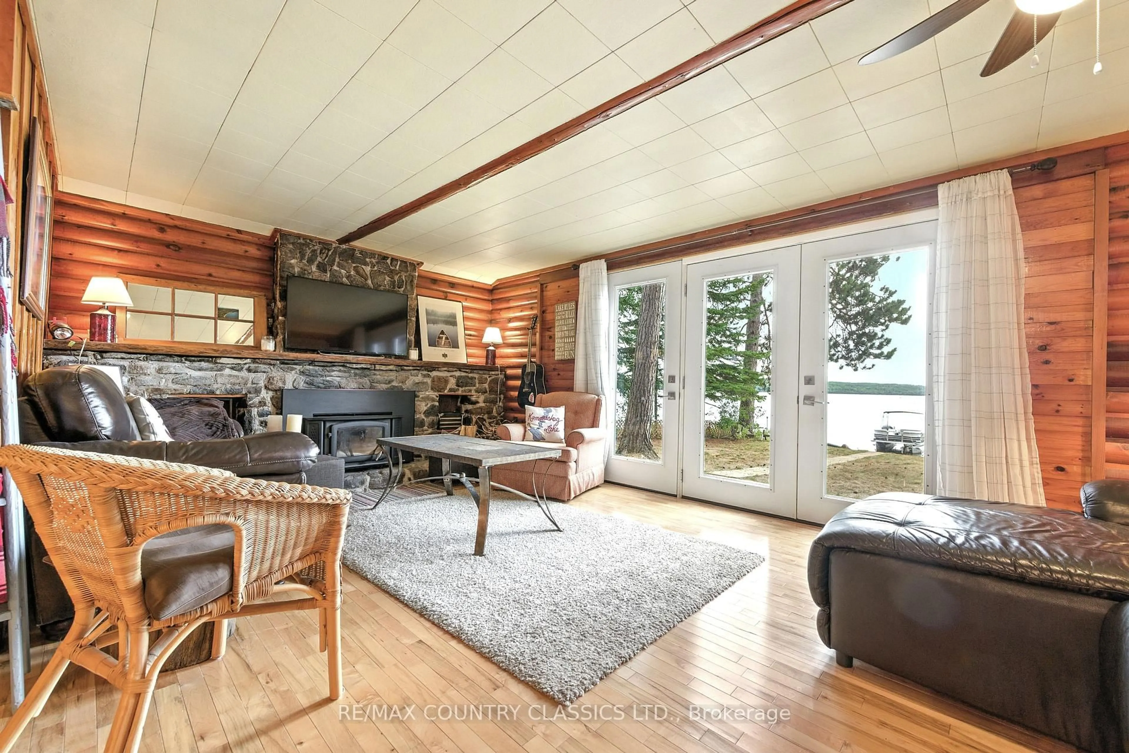 Living room with furniture, wood/laminate floor for 1258 Kamaniskeg Lake Rd, Combermere Ontario K0J 1L0