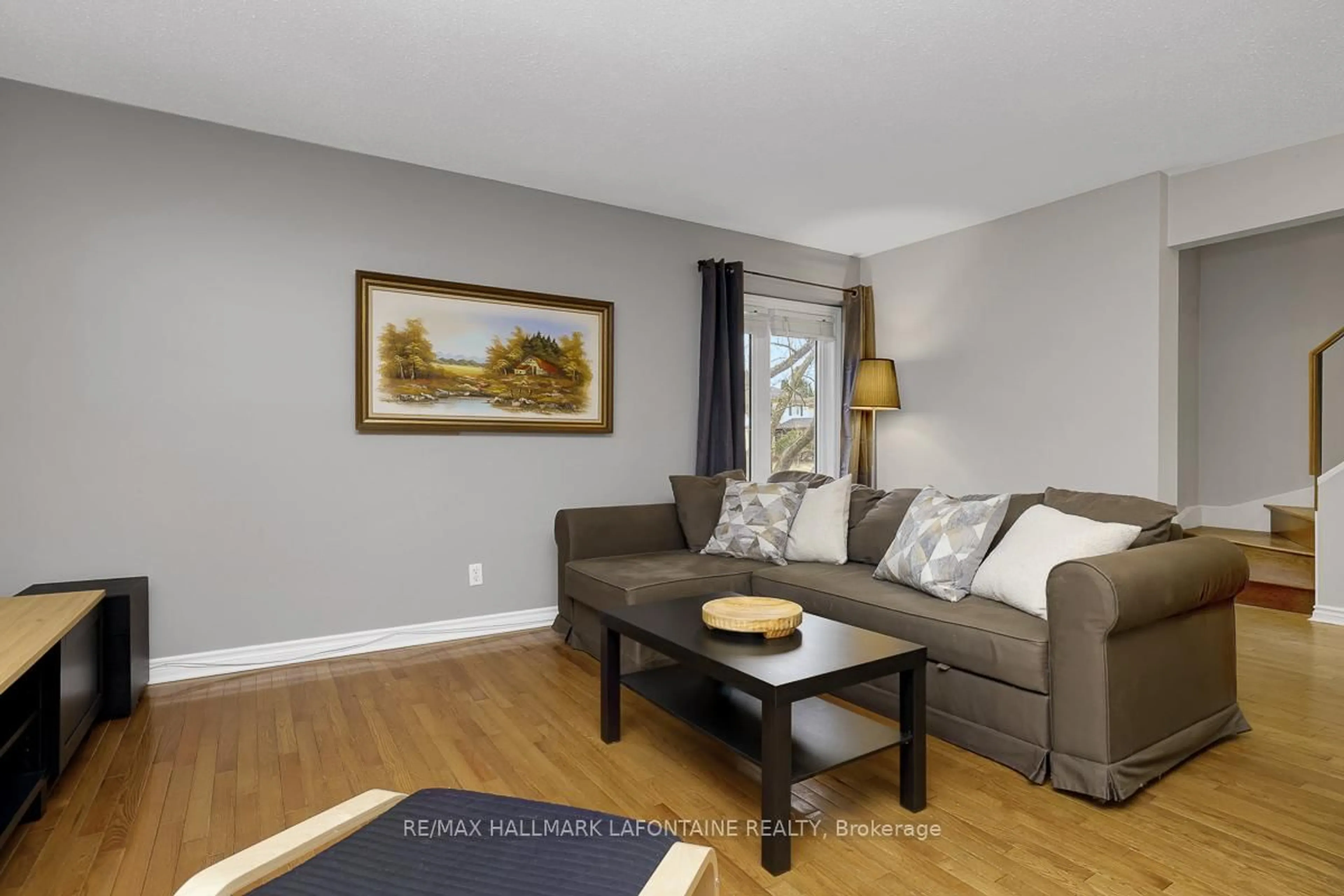 Living room with furniture, wood/laminate floor for 553 Apollo Way, Orleans Ontario K4A 1V1