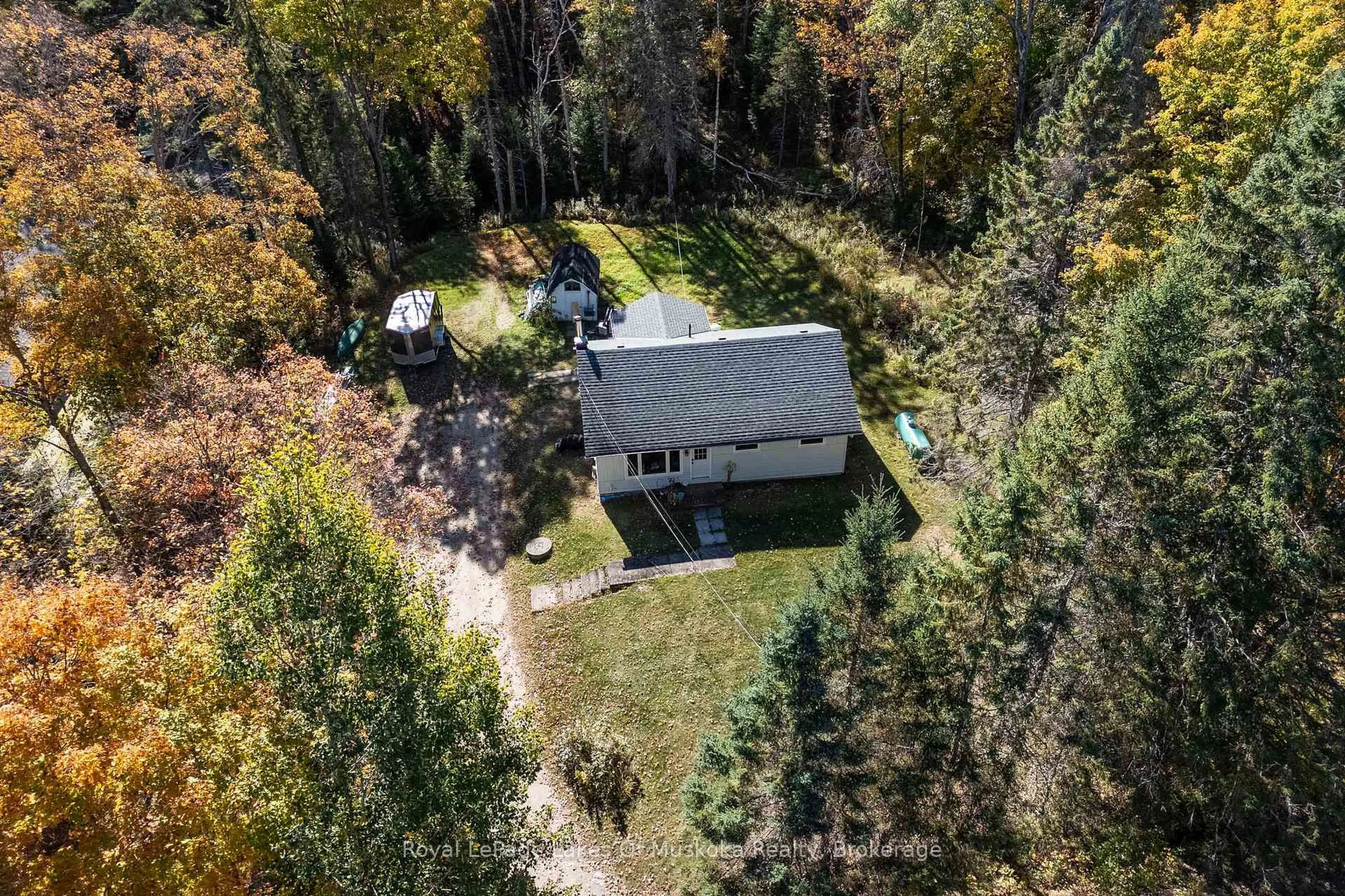 A pic from outside/outdoor area/front of a property/back of a property/a pic from drone, forest/trees view for 265 Chub Lake Rd, Huntsville Ontario P1H 1S4