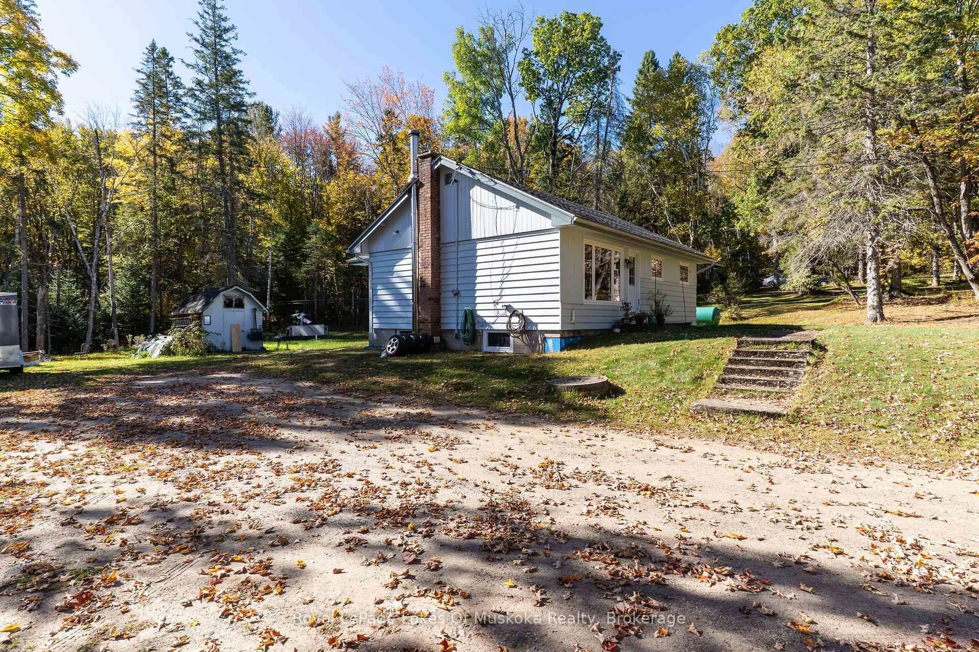 A pic from outside/outdoor area/front of a property/back of a property/a pic from drone, unknown for 265 Chub Lake Rd, Huntsville Ontario P1H 1S4