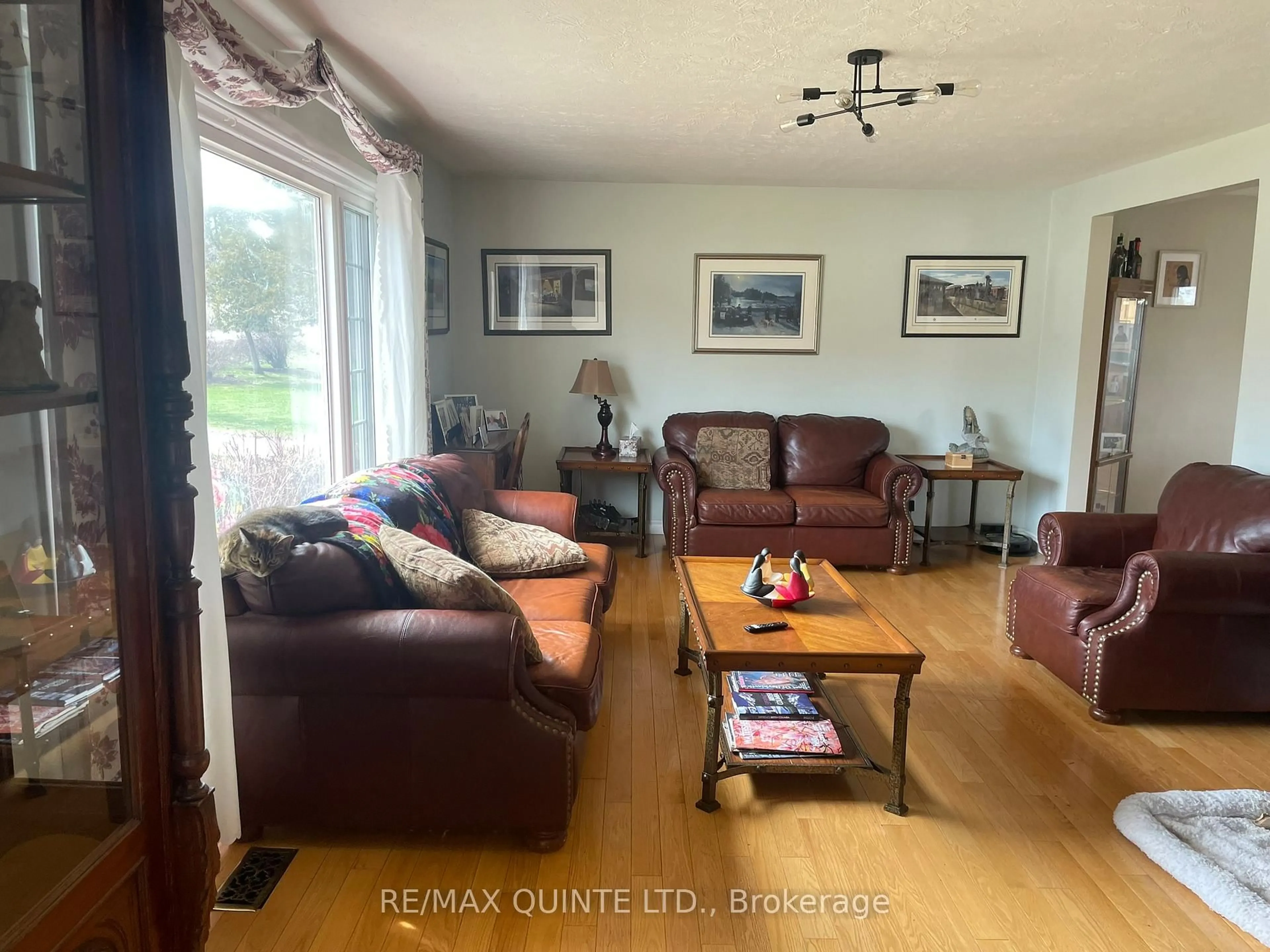 Living room with furniture, wood/laminate floor for 1752 County Road 3, Prince Edward County Ontario K0K 1A0