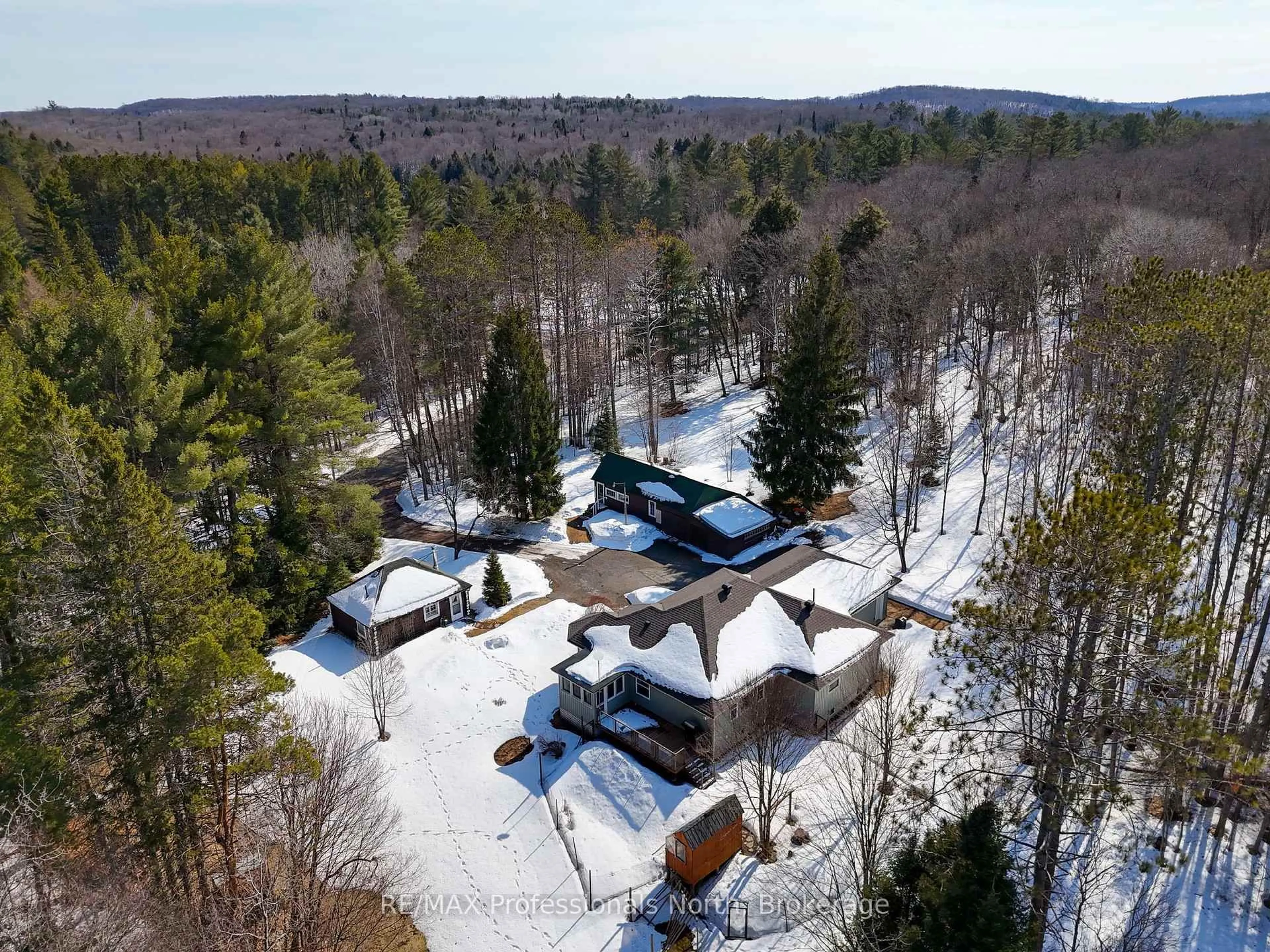 A pic from outside/outdoor area/front of a property/back of a property/a pic from drone, forest/trees view for 34 Old Novar Rd, Huntsville Ontario P1H 2J2