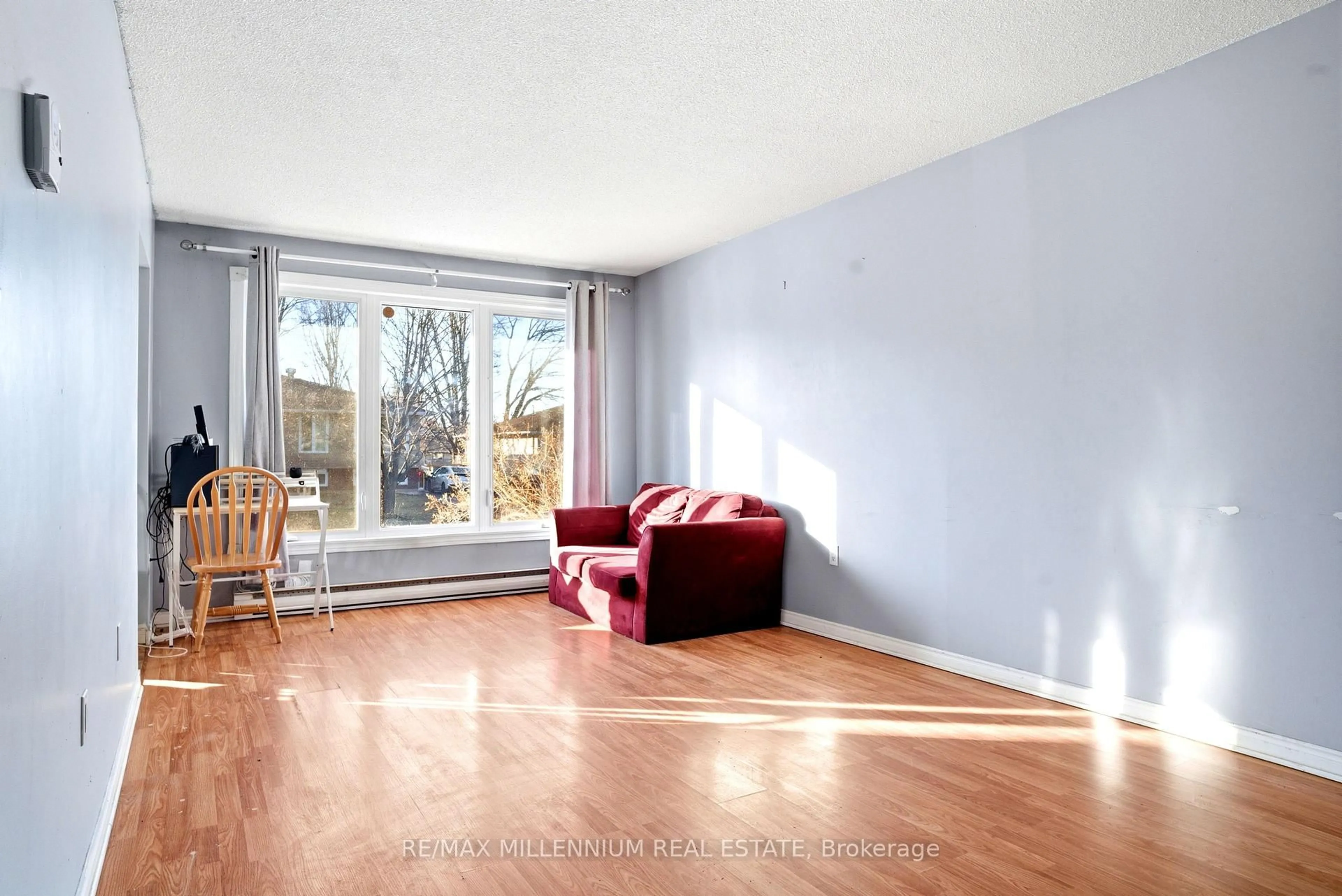 Living room with furniture, wood/laminate floor for 8 PLUMTREE Pl, North Bay Ontario P1A 3Y6