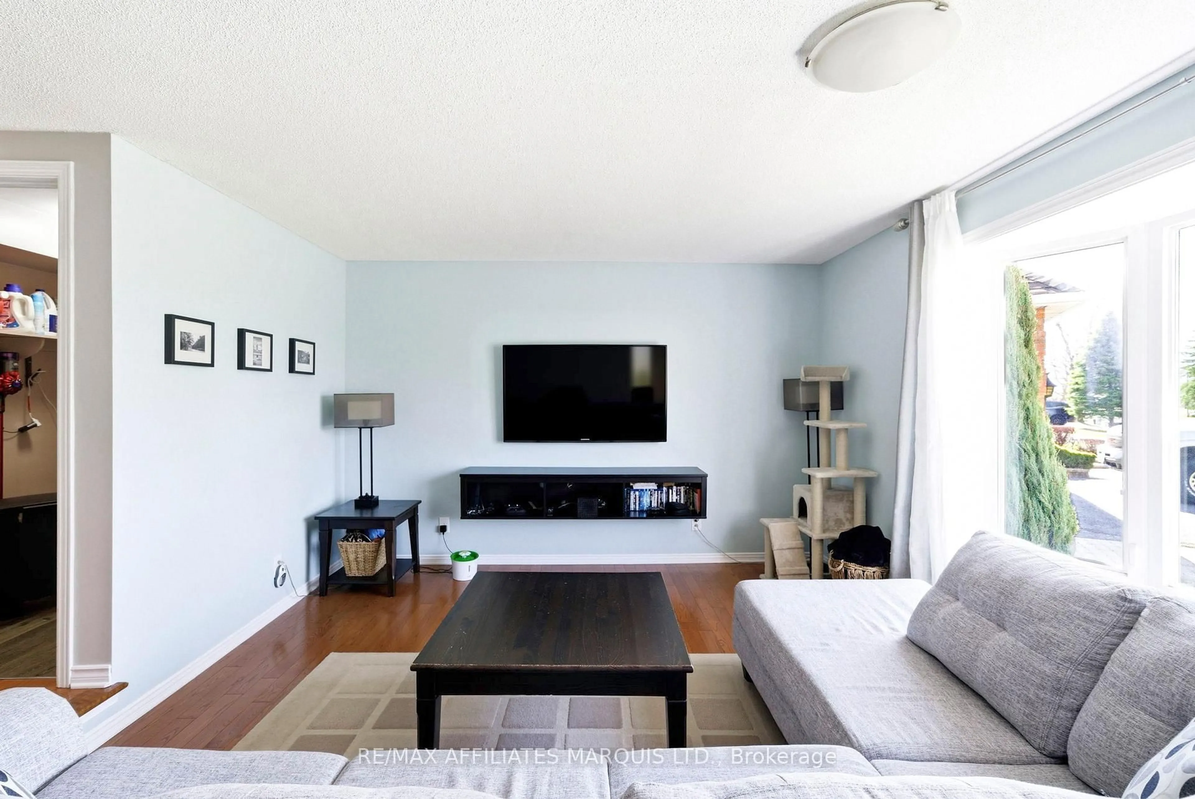 Living room with furniture, wood/laminate floor for 884 Kenyon Cres, Cornwall Ontario K6H 6Z1