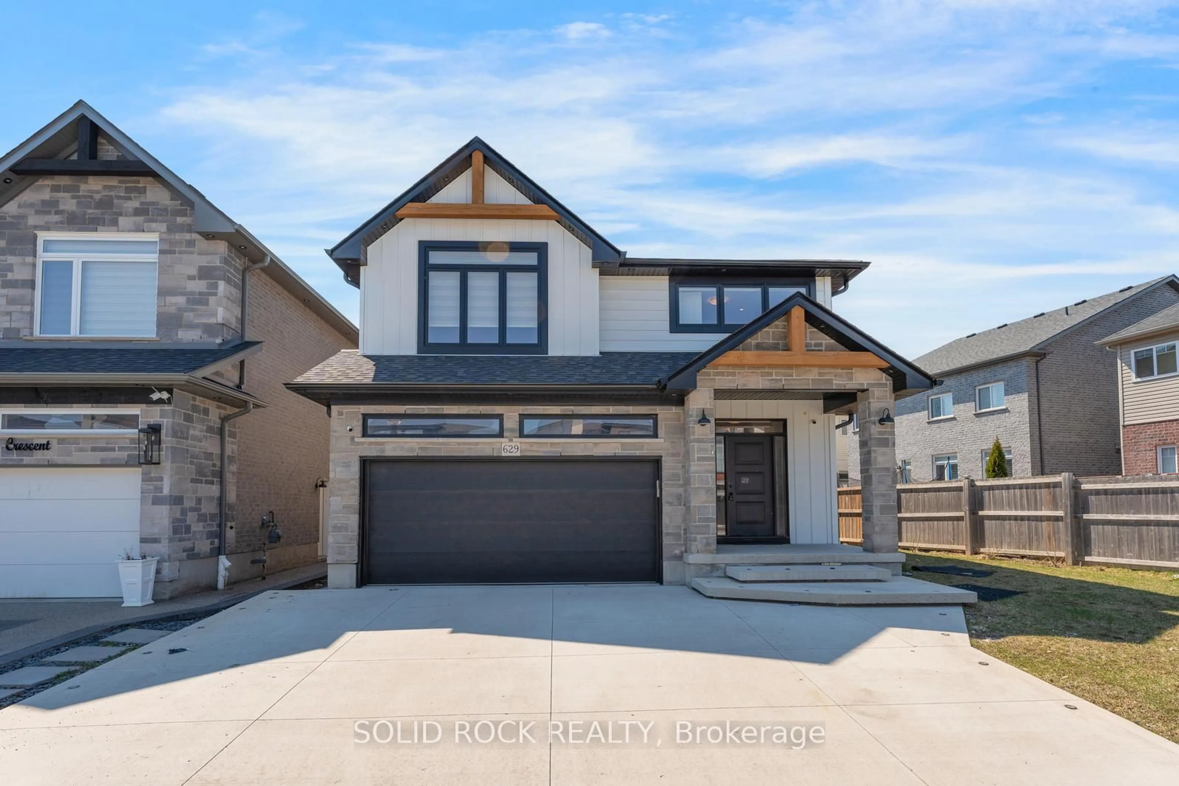 Home with brick exterior material, street for 629 Doonwoods Cres, Kitchener Ontario N2P 0E6