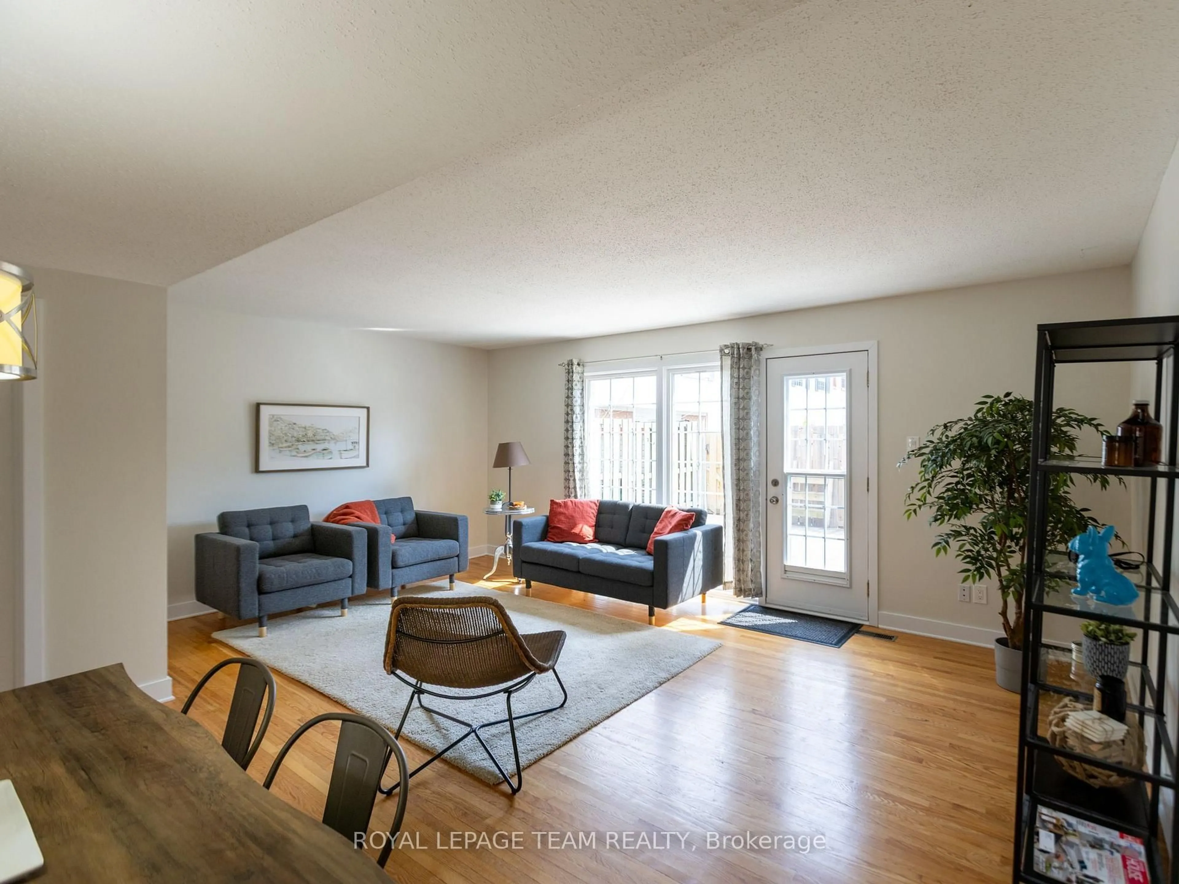 Living room with furniture, wood/laminate floor for 71 Monterey Dr, Ottawa Ontario K2H 7A9