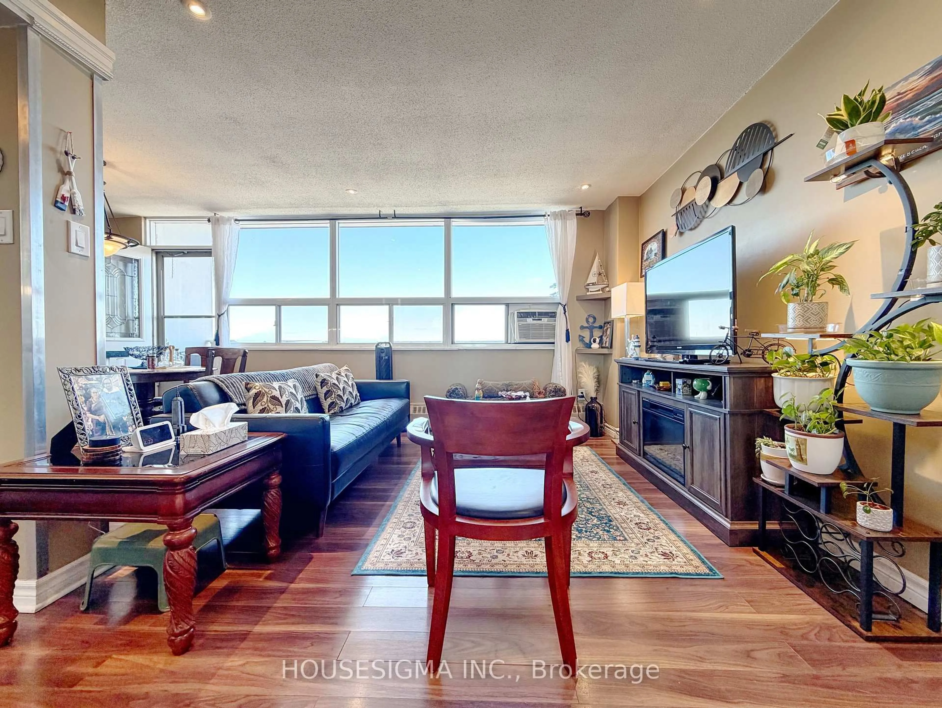 Living room with furniture, wood/laminate floor for 15 Albright Rd #1002, Hamilton Ontario L8K 5J2