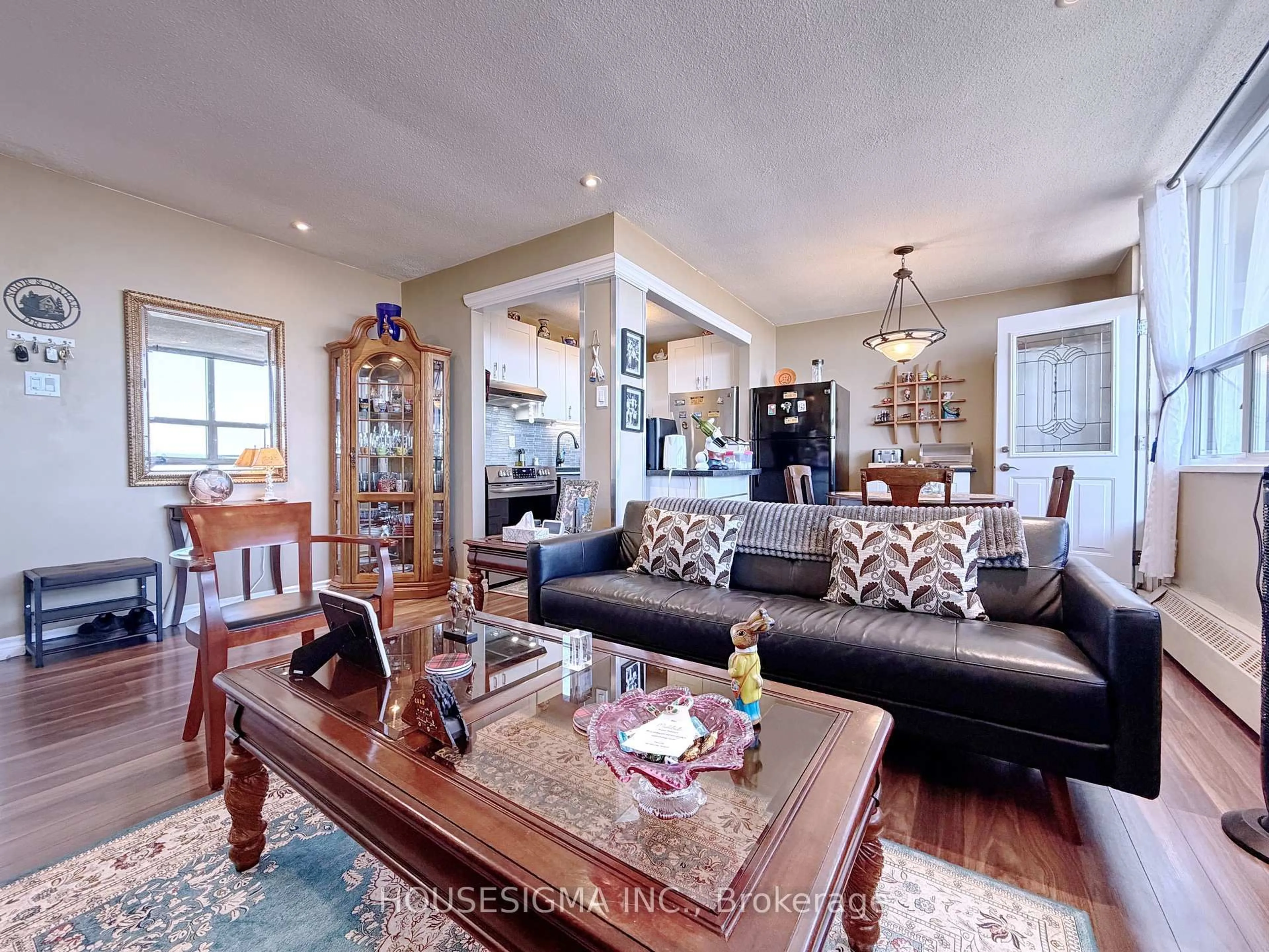 Living room with furniture, wood/laminate floor for 15 Albright Rd #1002, Hamilton Ontario L8K 5J2