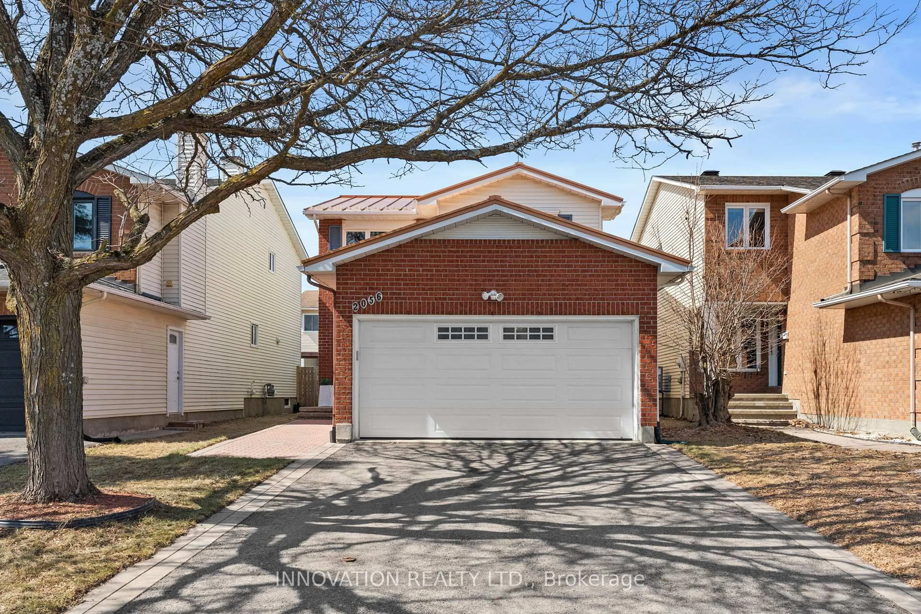 Home with vinyl exterior material, street for 2056 Wildflower Dr, Orleans Ontario K1E 3R3