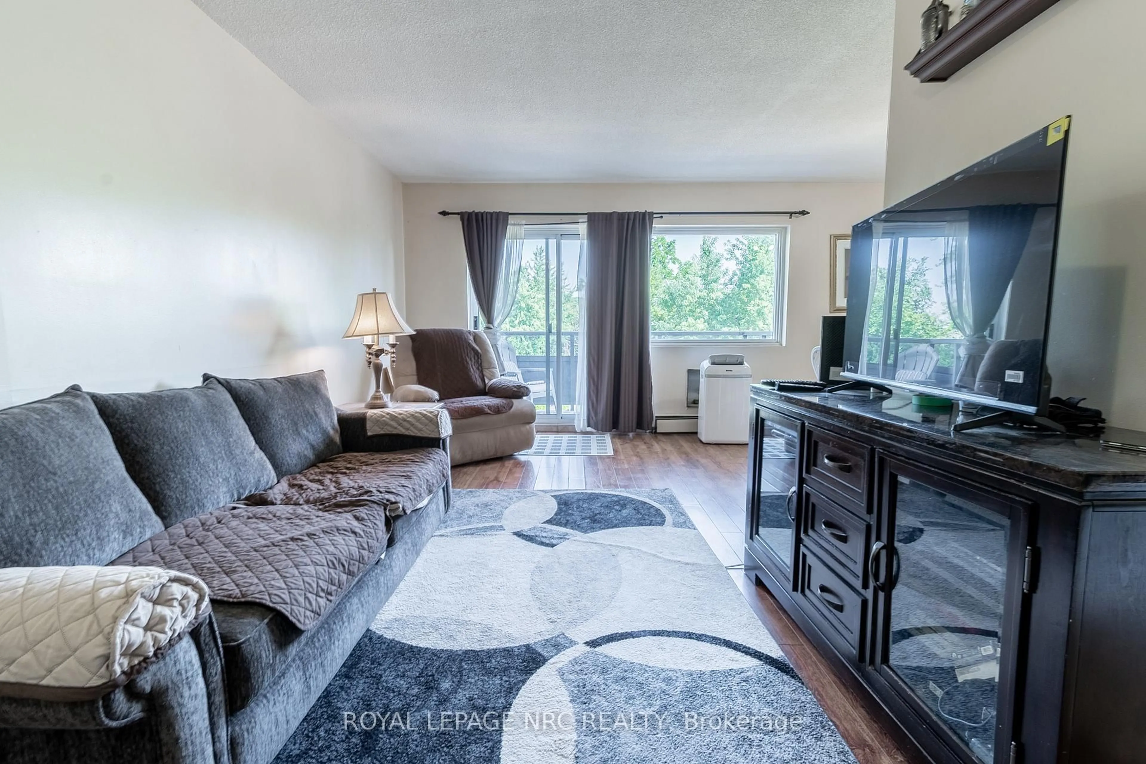 Living room with furniture, unknown for 242 Oakdale Ave #316, St. Catharines Ontario L2P 3K5