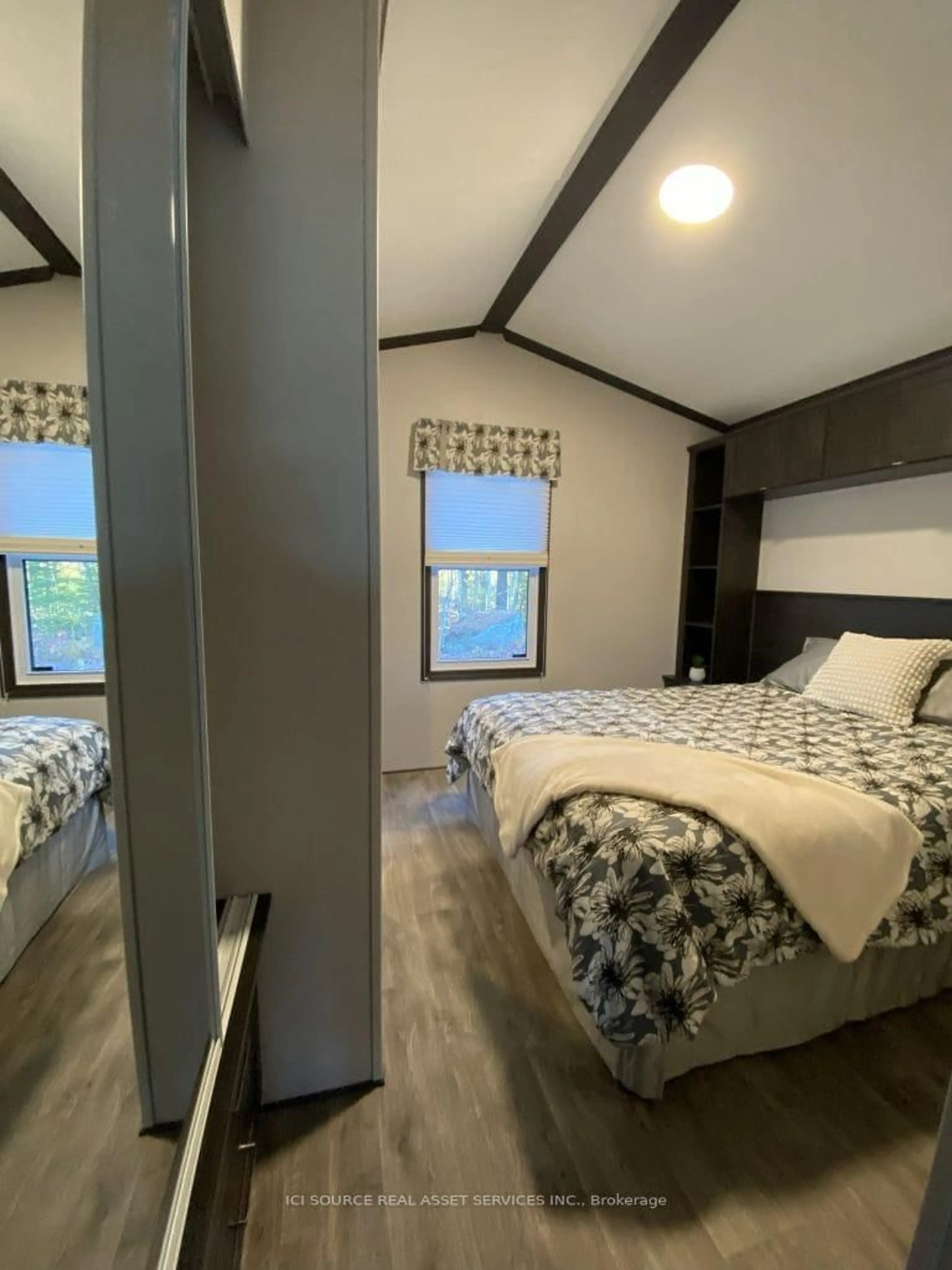 Bedroom with bed, wood/laminate floor for 1047 Bonnie Lake Camp Rd #TRILM, Bracebridge Ontario P1L 1W9