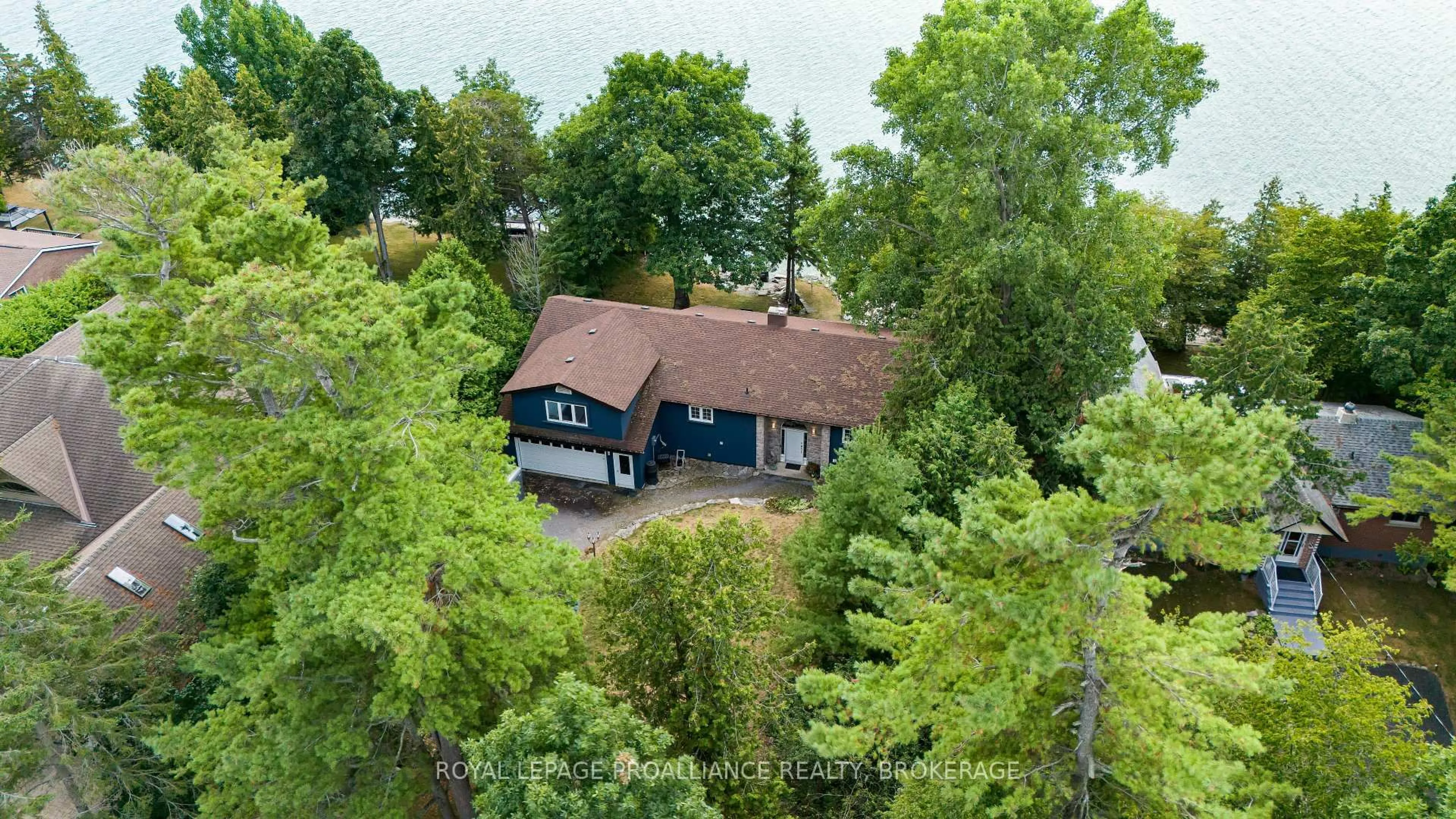 A pic from outside/outdoor area/front of a property/back of a property/a pic from drone, forest/trees view for 182 Nicholson Point Rd, Bath Ontario K0H 1G0