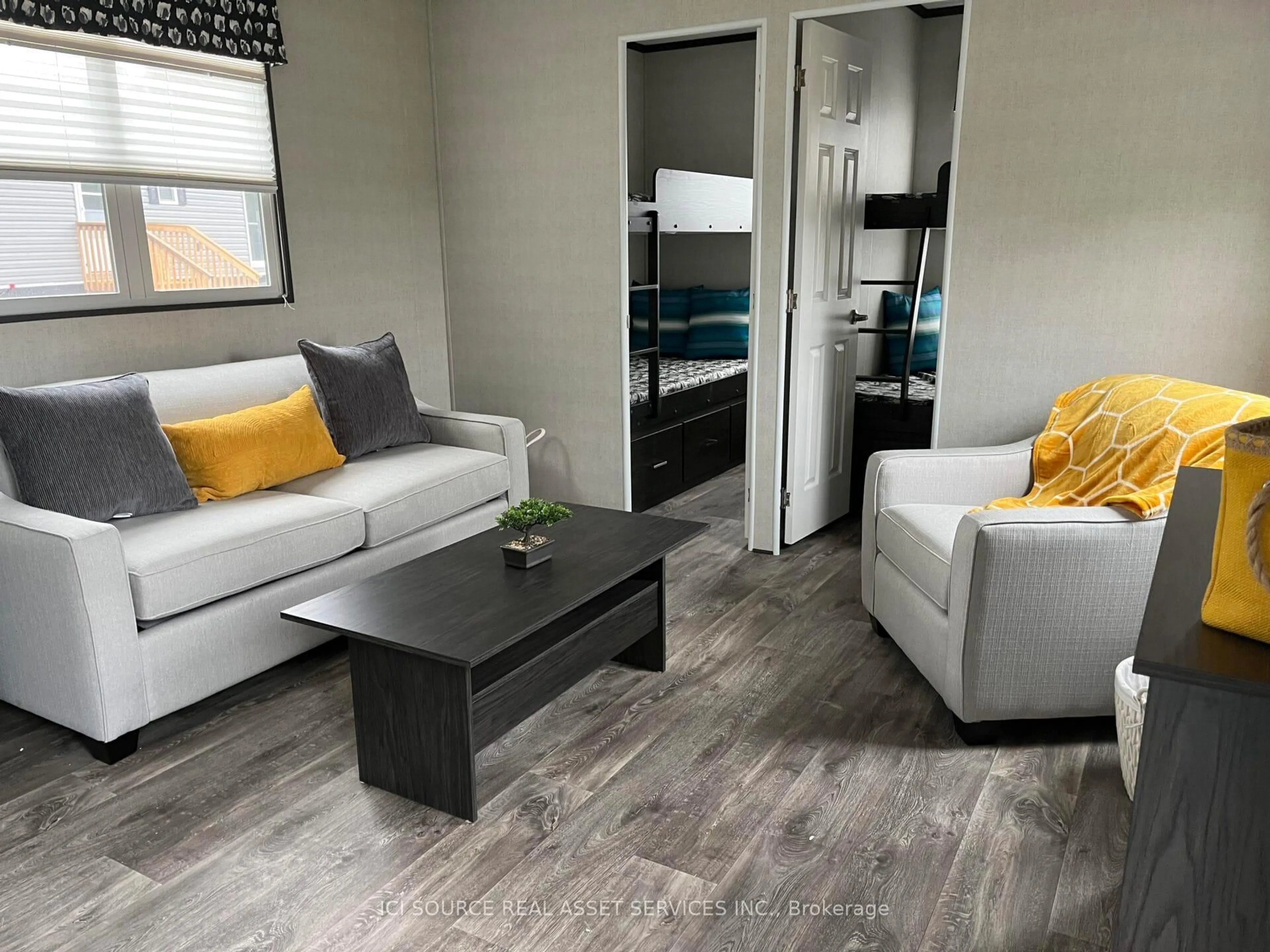 Living room with furniture, wood/laminate floor for 1047 Bonnie Lake Camp Rd #LKR026, Bracebridge Ontario P1L 1W9