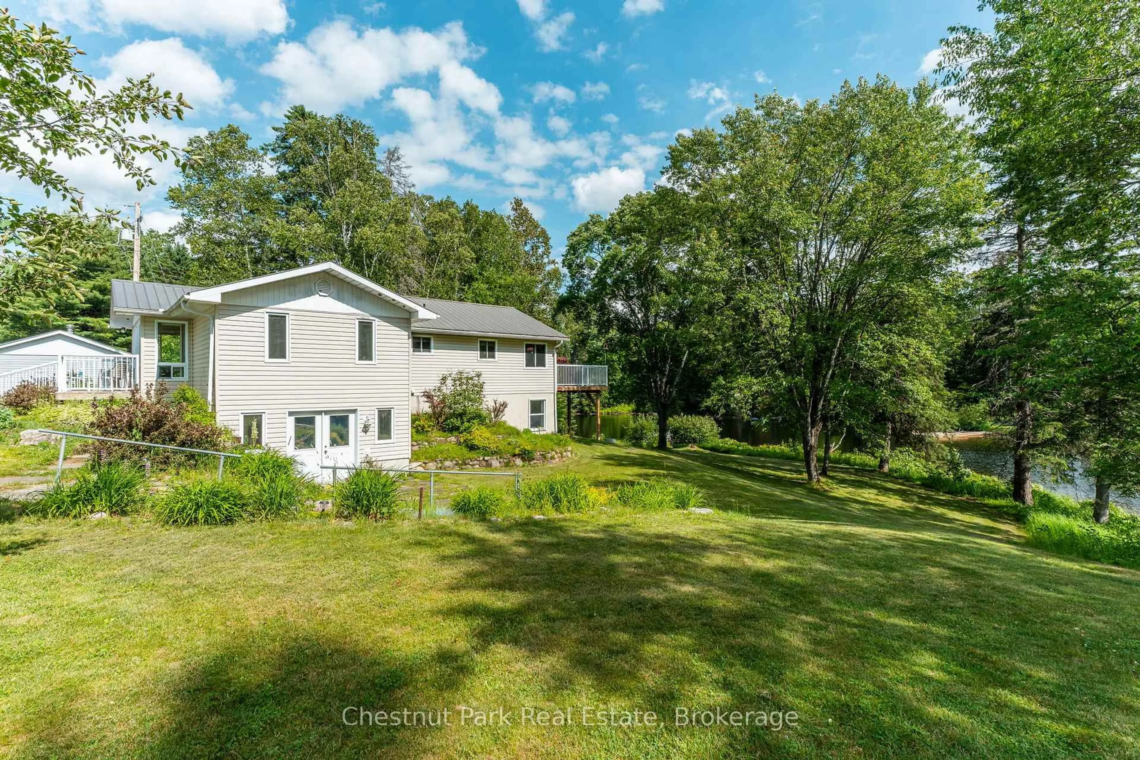 A pic from outside/outdoor area/front of a property/back of a property/a pic from drone, water/lake/river/ocean view for 1054 Green Lake Rd, Algonquin Highlands Ontario K0M 1S0