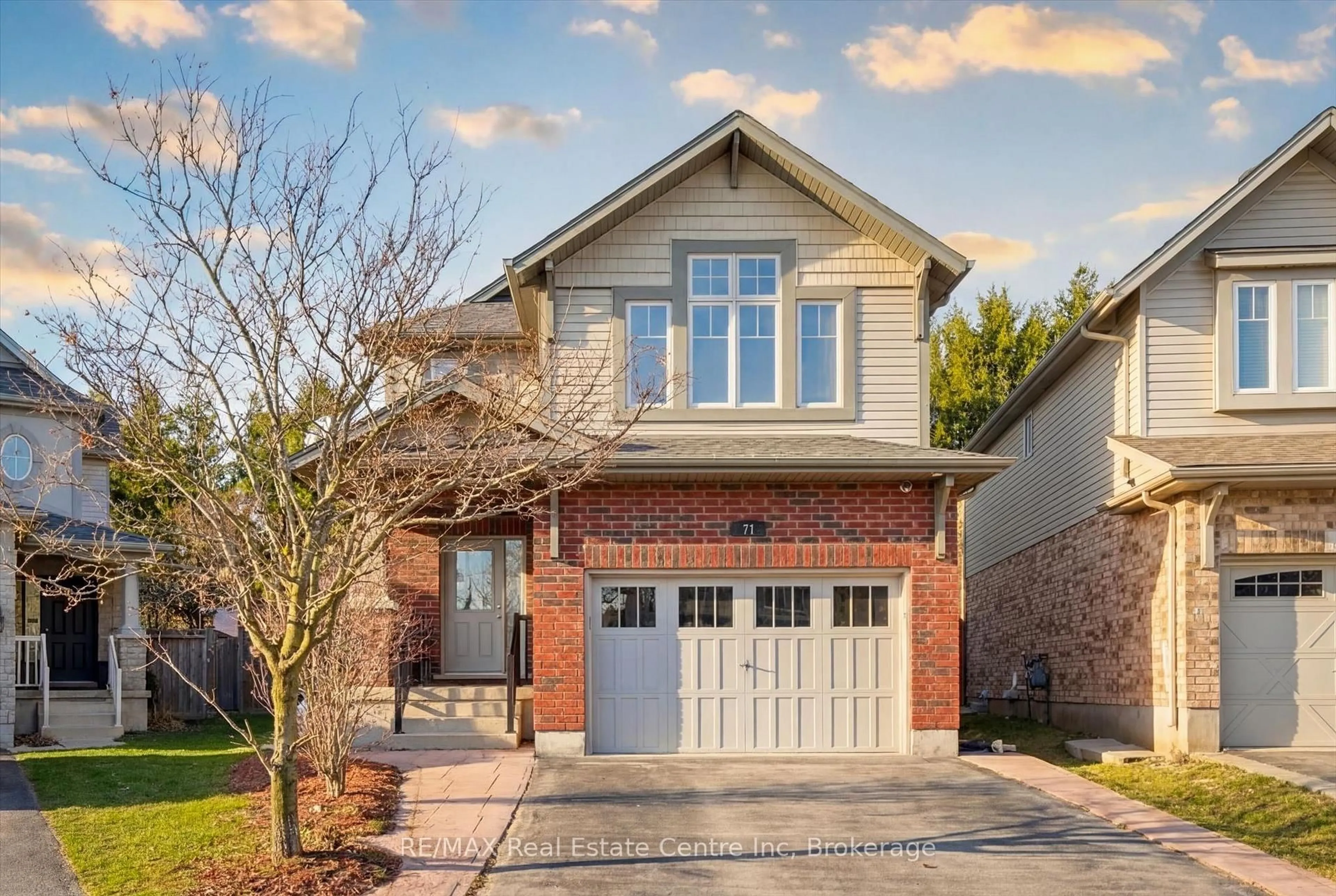 Home with brick exterior material, street for 71 Laughland Lane, Guelph Ontario N1L 0C6