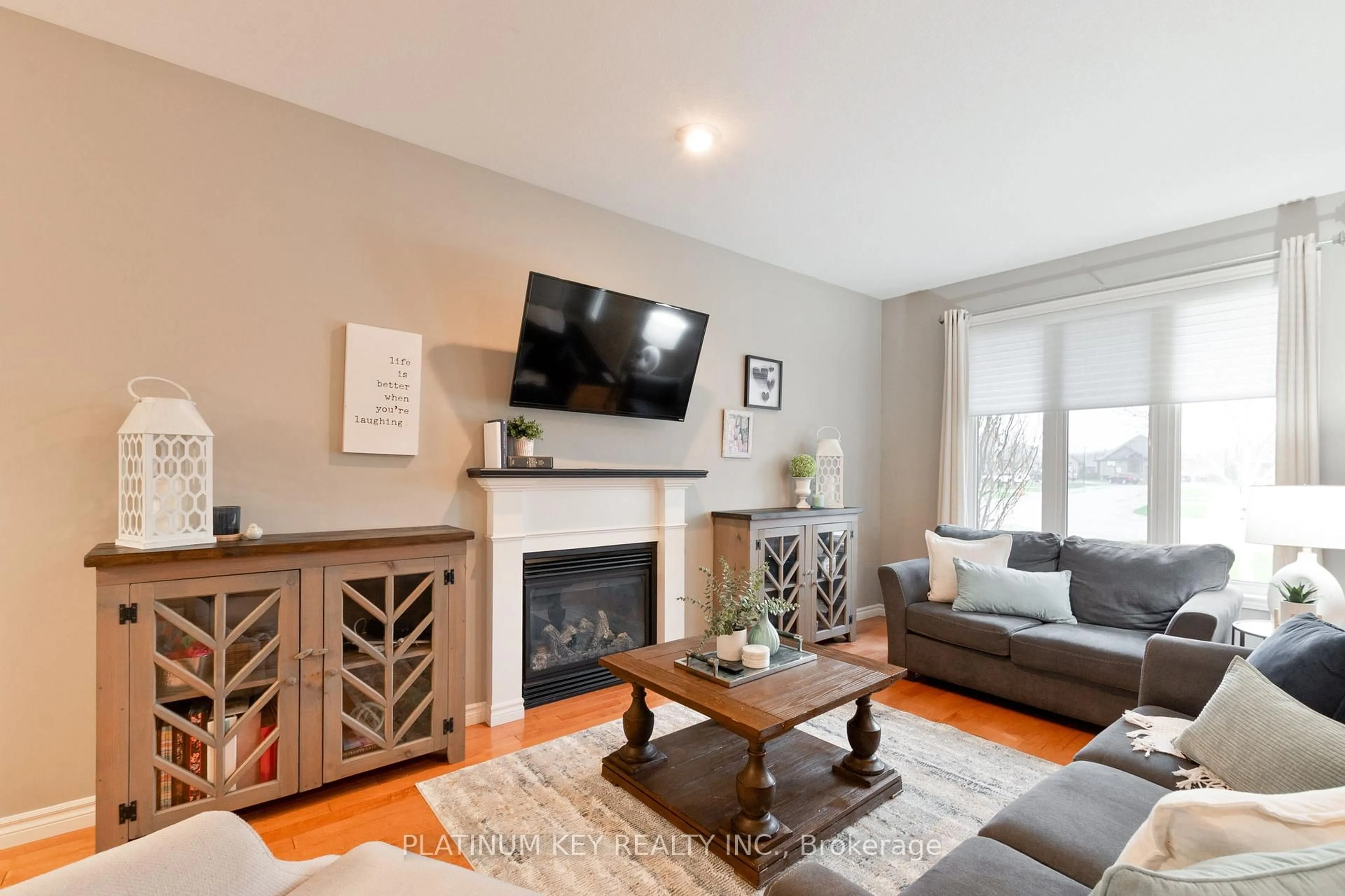 Living room with furniture, wood/laminate floor for 56 Cassie Cres, Strathroy-Caradoc Ontario N7G 4E2