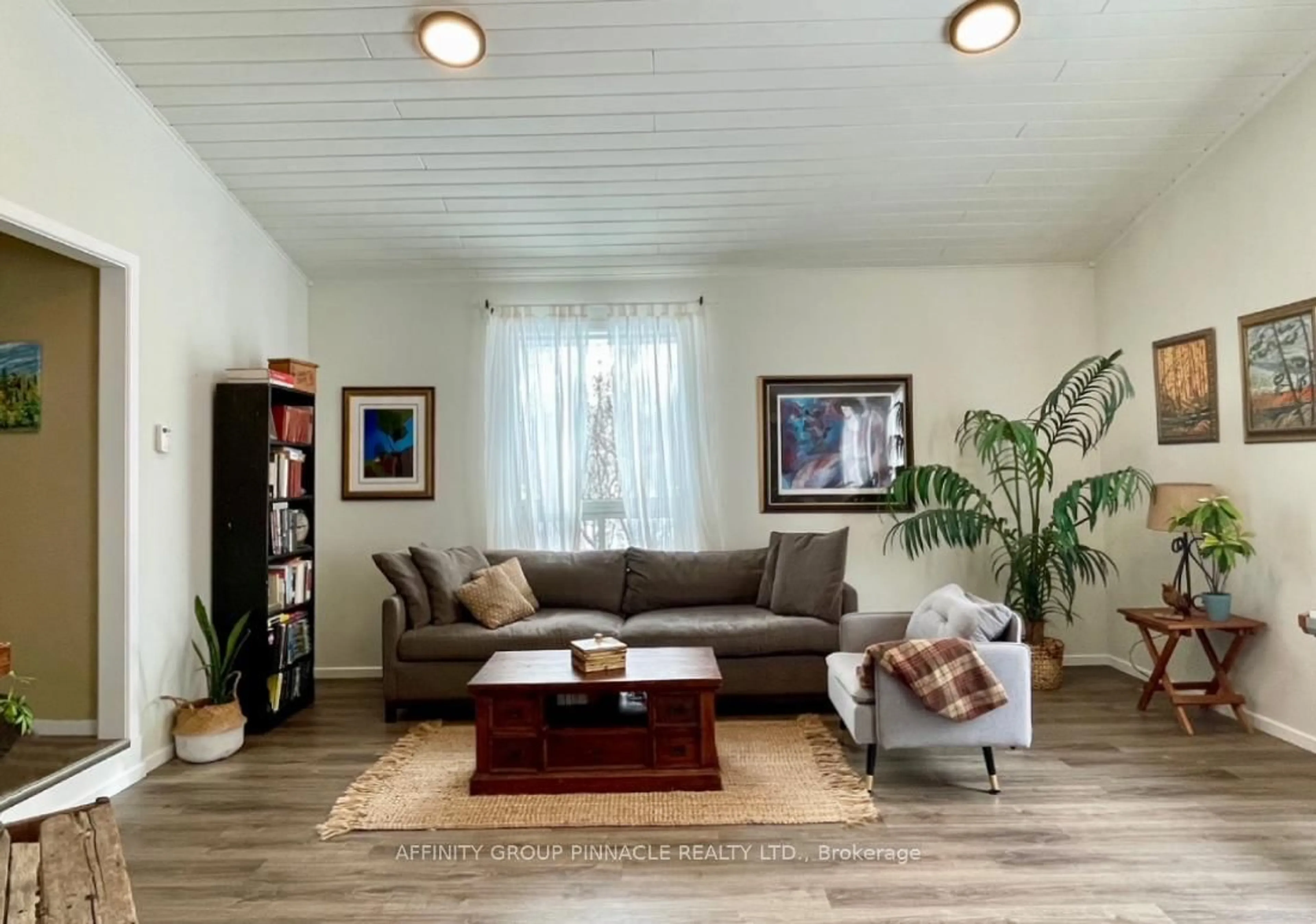 Living room with furniture, wood/laminate floor for 96 Pinewood Rd, McDougall Ontario P2A 2W7