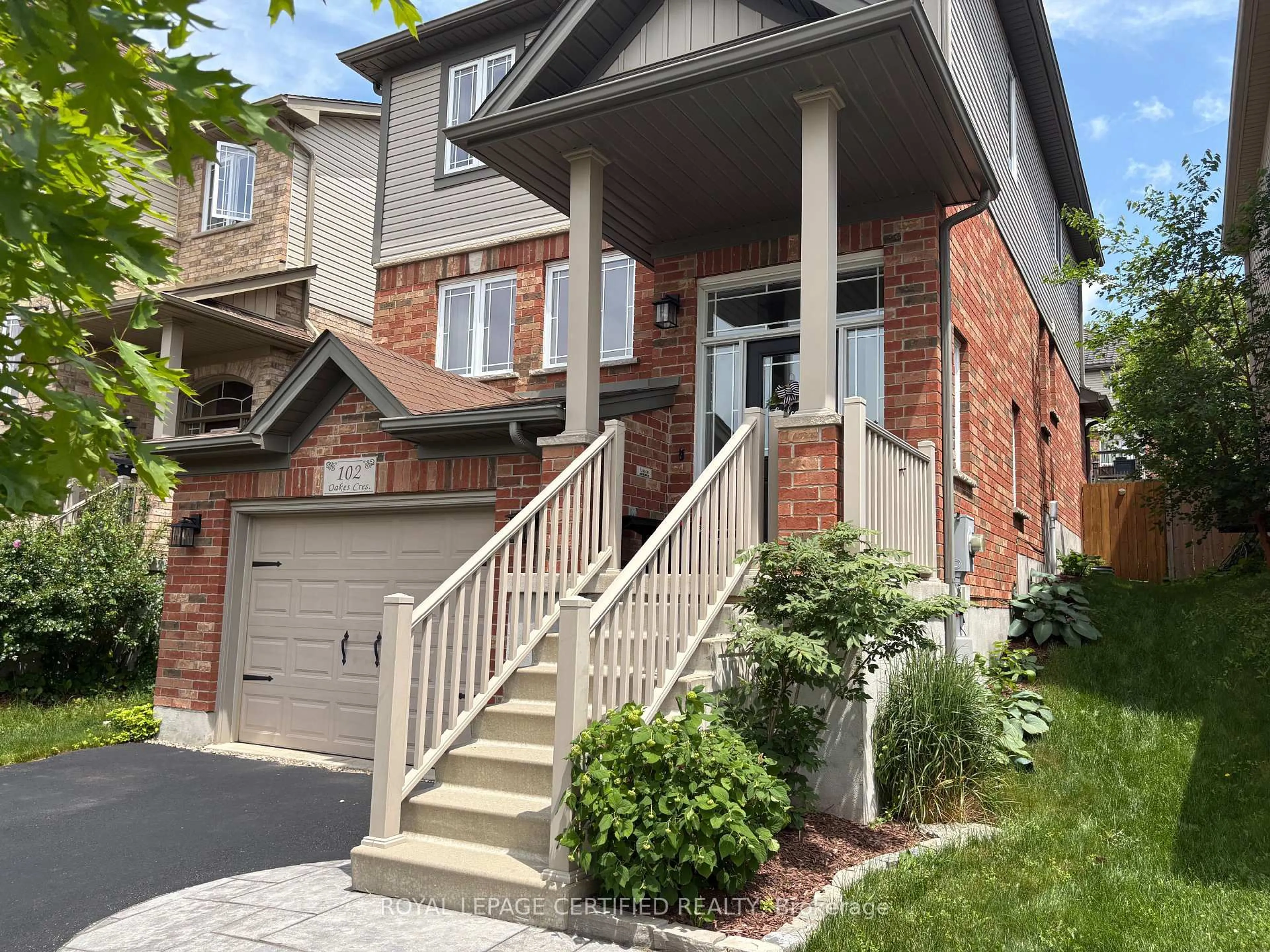 Home with brick exterior material, street for 102 Oakes Cres, Guelph Ontario N1E 0J5