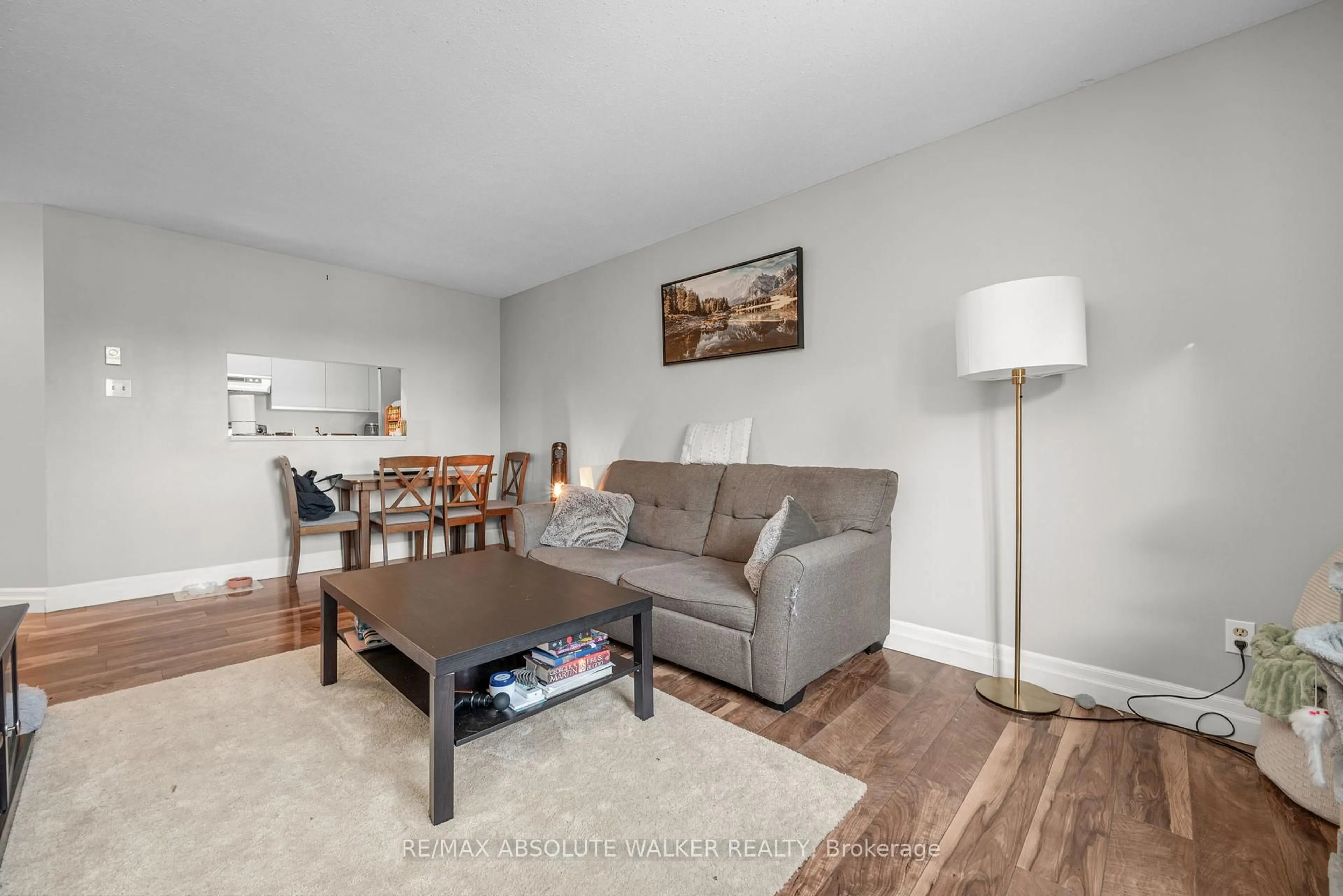 Living room with furniture, wood/laminate floor for 250 Brittany Dr #318, Ottawa Ontario K1K 4M1
