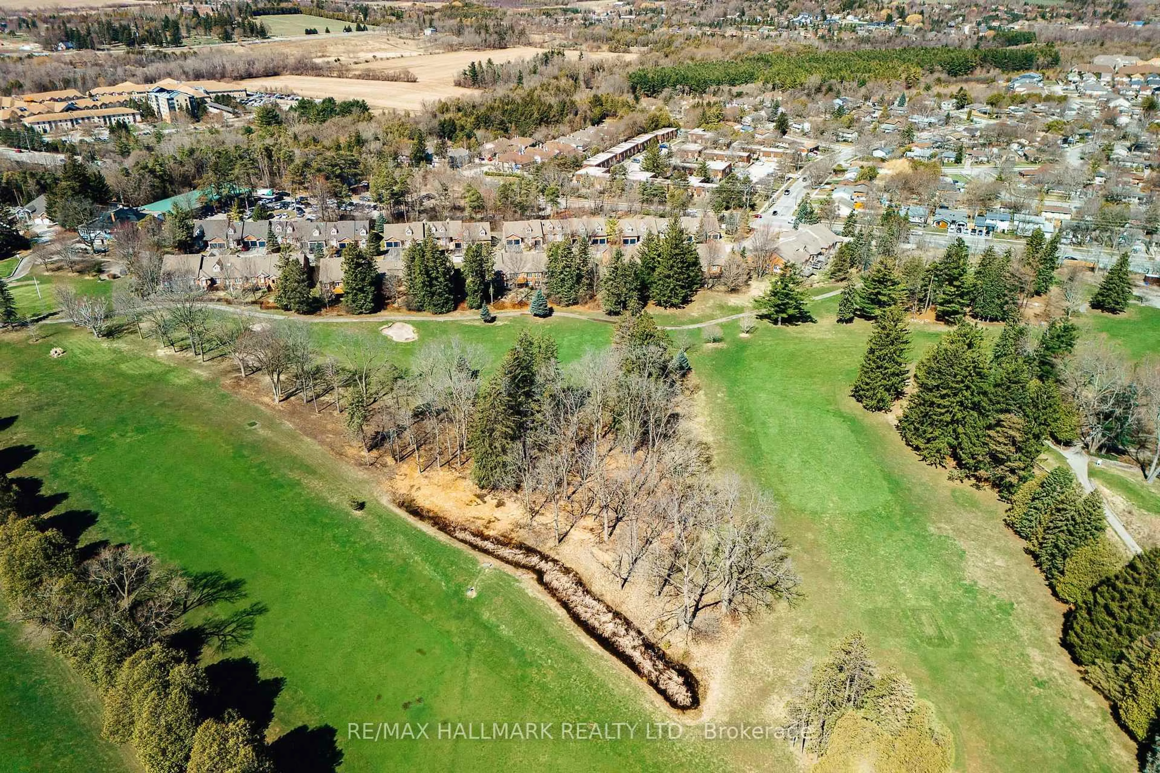 A pic from outside/outdoor area/front of a property/back of a property/a pic from drone, forest/trees view for 12 Fairway Lane, Guelph Ontario N1E 7A9