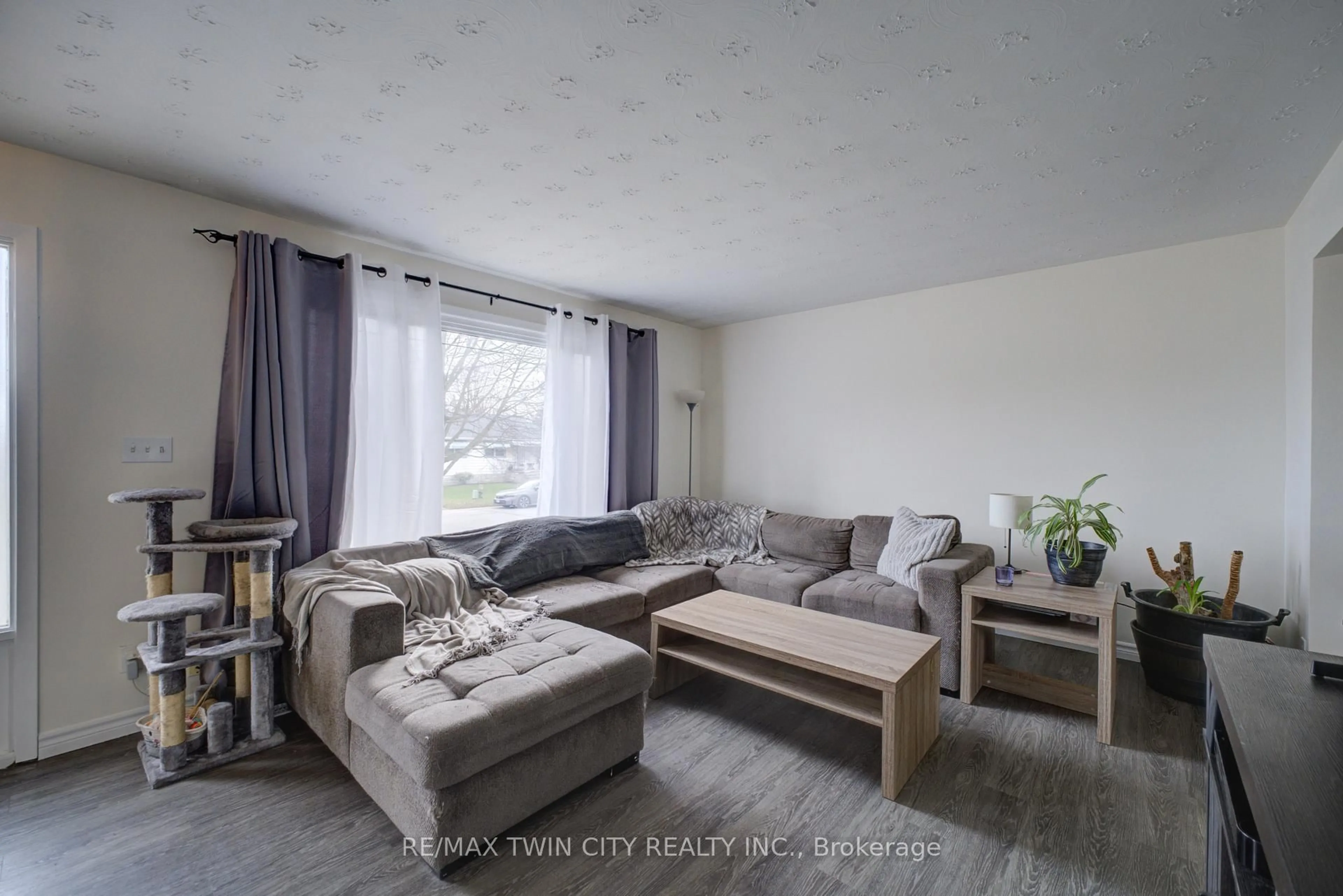 Living room with furniture, wood/laminate floor for 32 Morley Ave #B, Brantford Ontario N3S 7A9