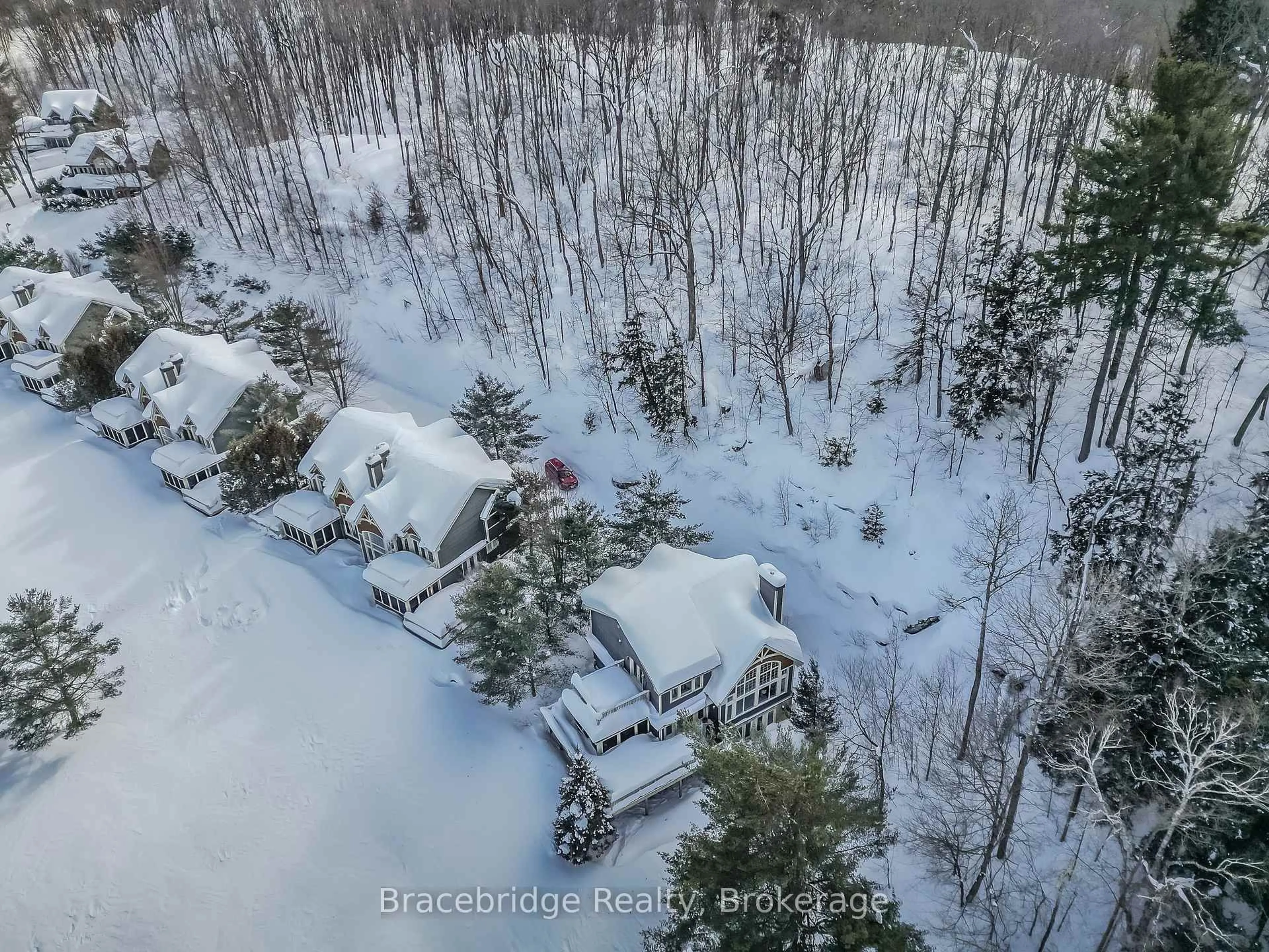 A pic from outside/outdoor area/front of a property/back of a property/a pic from drone, forest/trees view for 3876 Muskoka Rd 118 Highway #Water's Edge W1, Muskoka Lakes Ontario P0B 1J0
