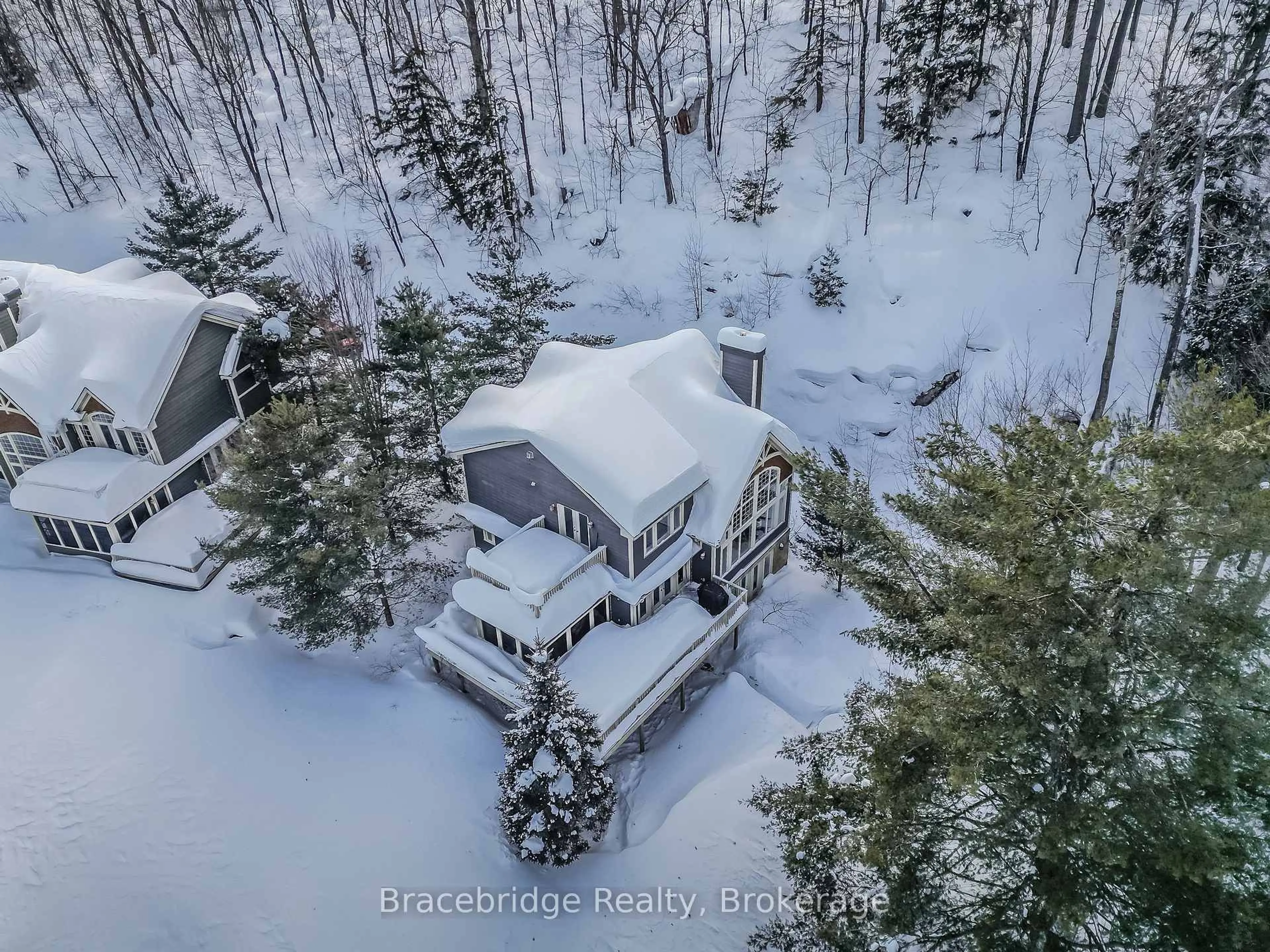 A pic from outside/outdoor area/front of a property/back of a property/a pic from drone, forest/trees view for 3876 Muskoka Rd 118 Highway #Water's Edge W1, Muskoka Lakes Ontario P0B 1J0