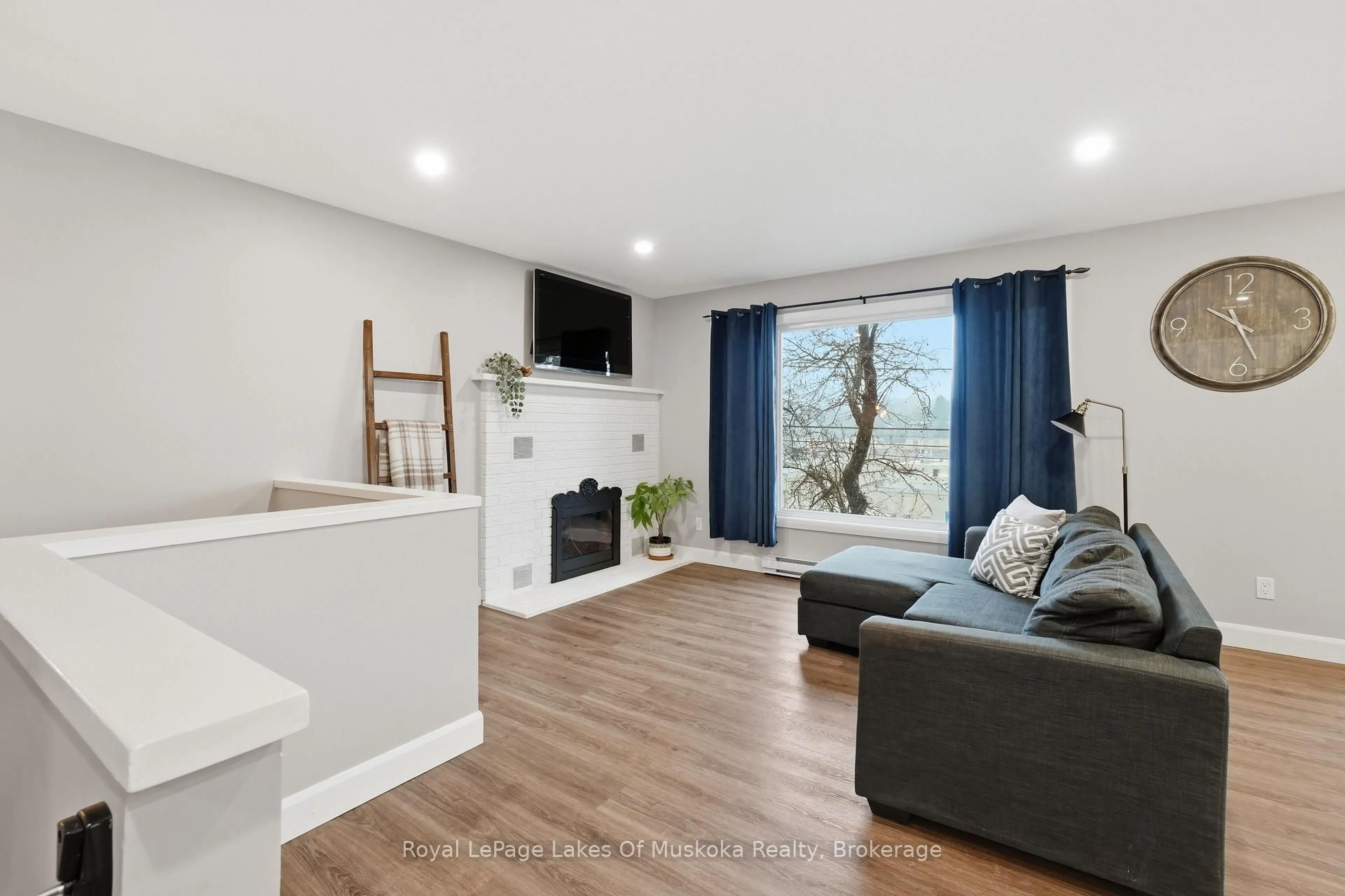 Living room with furniture, wood/laminate floor for 12 Manominee St, Huntsville Ontario P1H 1H2