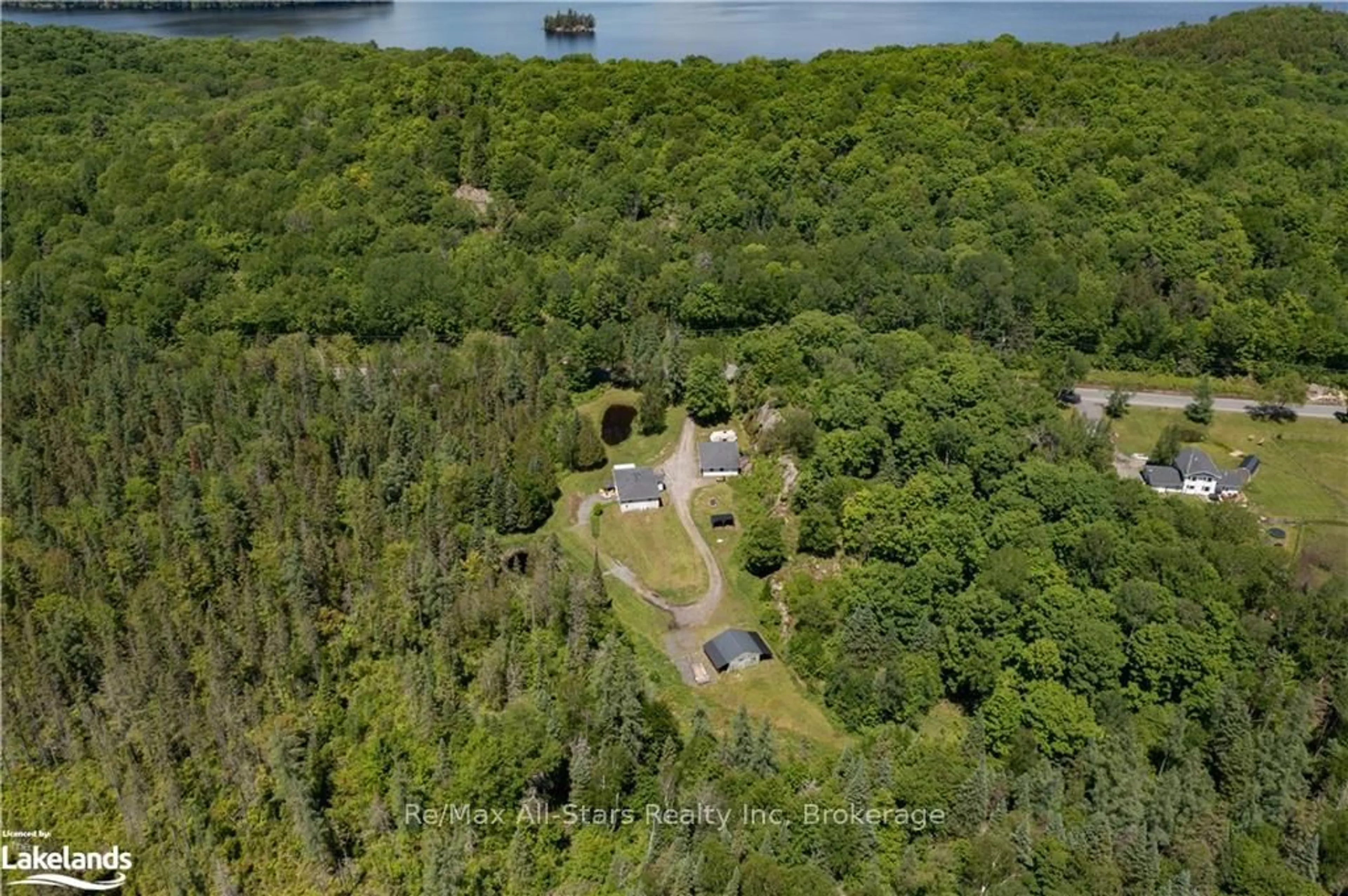 A pic from outside/outdoor area/front of a property/back of a property/a pic from drone, forest/trees view for 410 Etwell Rd, Huntsville Ontario P1H 2J2