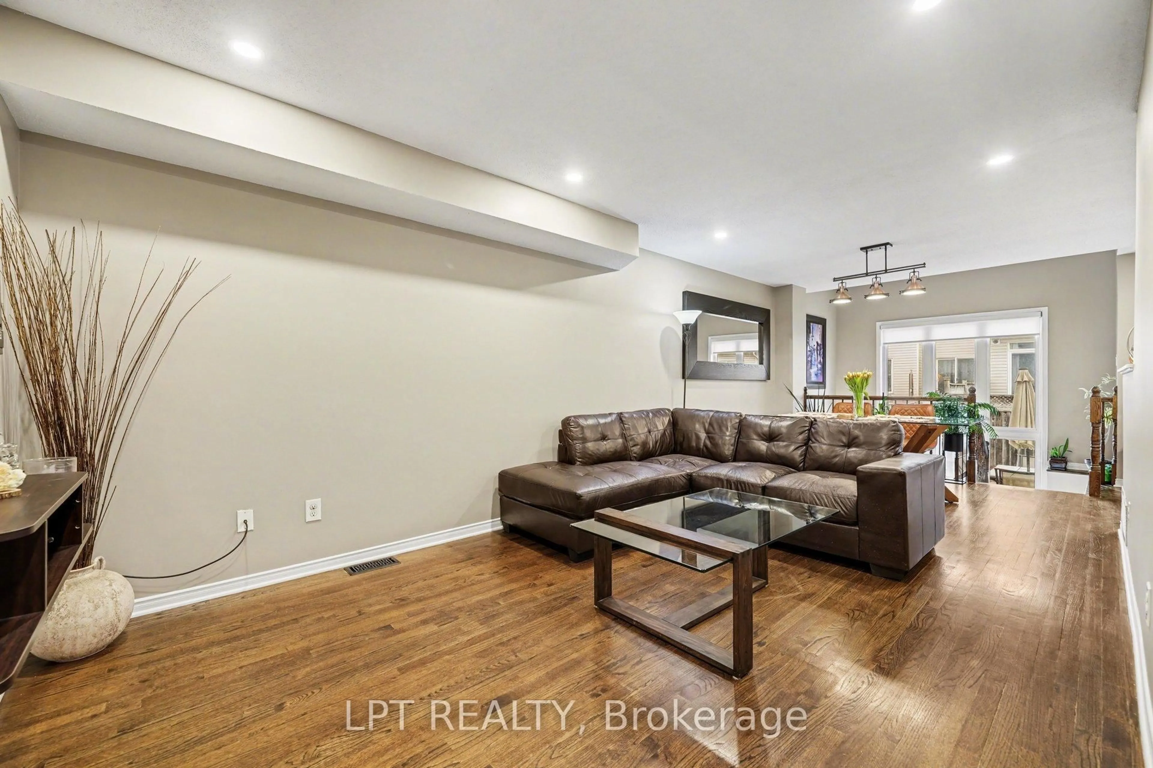 Living room with furniture, wood/laminate floor for 224 Lamplighters Dr, Ottawa Ontario K2J 0K7