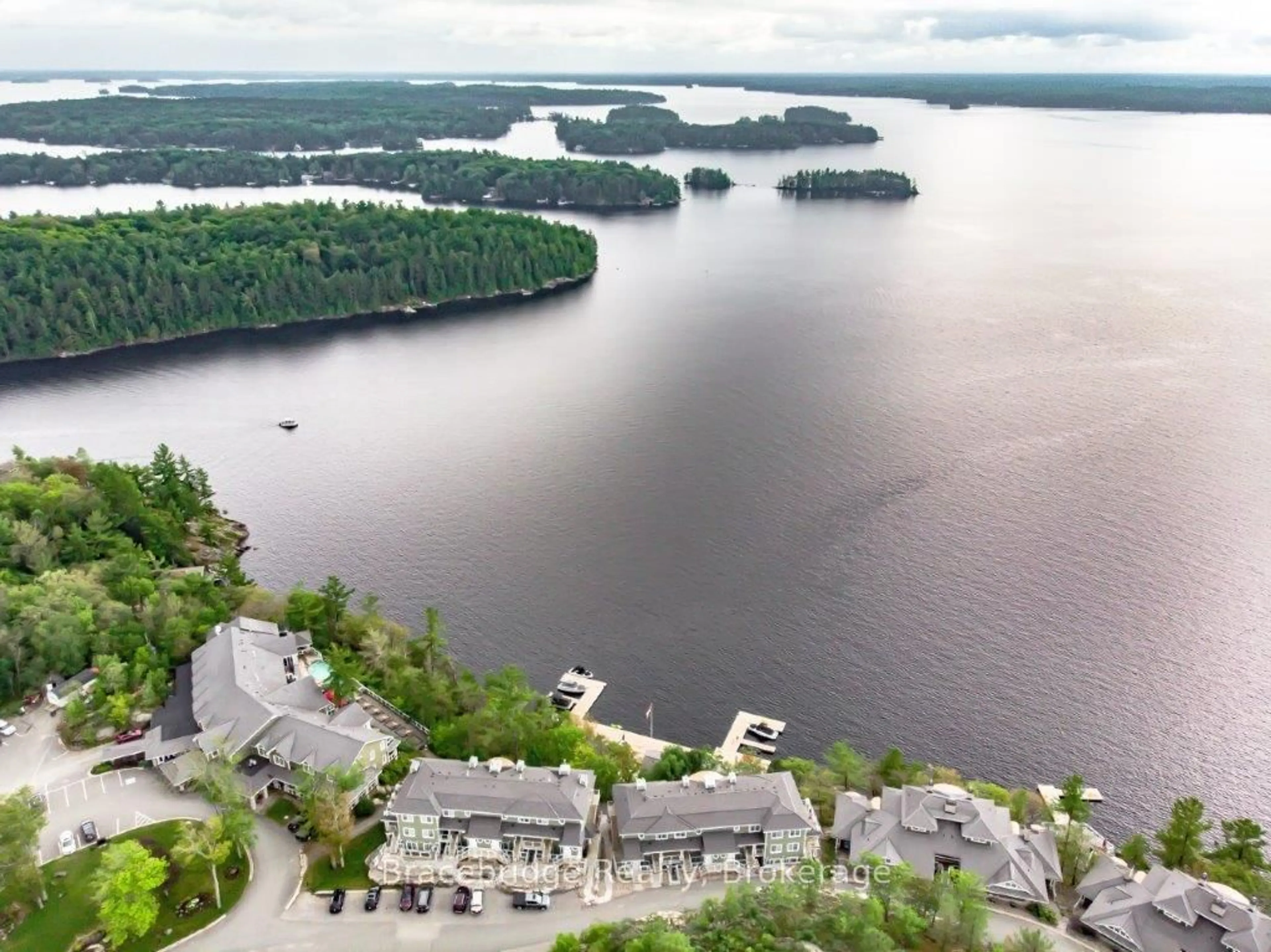 A pic from outside/outdoor area/front of a property/back of a property/a pic from drone, water/lake/river/ocean view for 1869 Muskoka Rd 118 Highway #B102-C1, Muskoka Lakes Ontario P1L 1W8