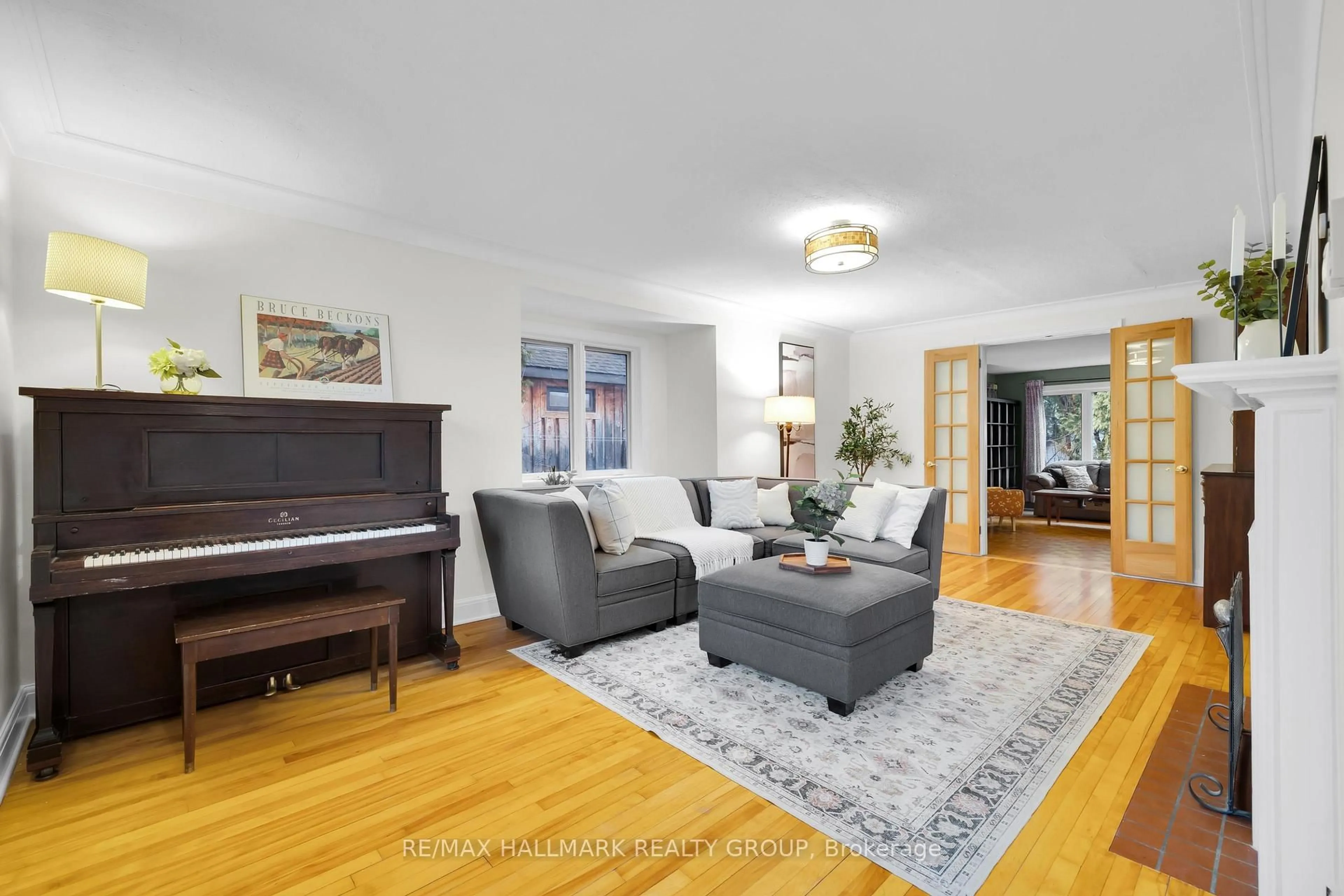 Living room with furniture, wood/laminate floor for 448 Brennan Ave, Ottawa Ontario K1Z 6J8