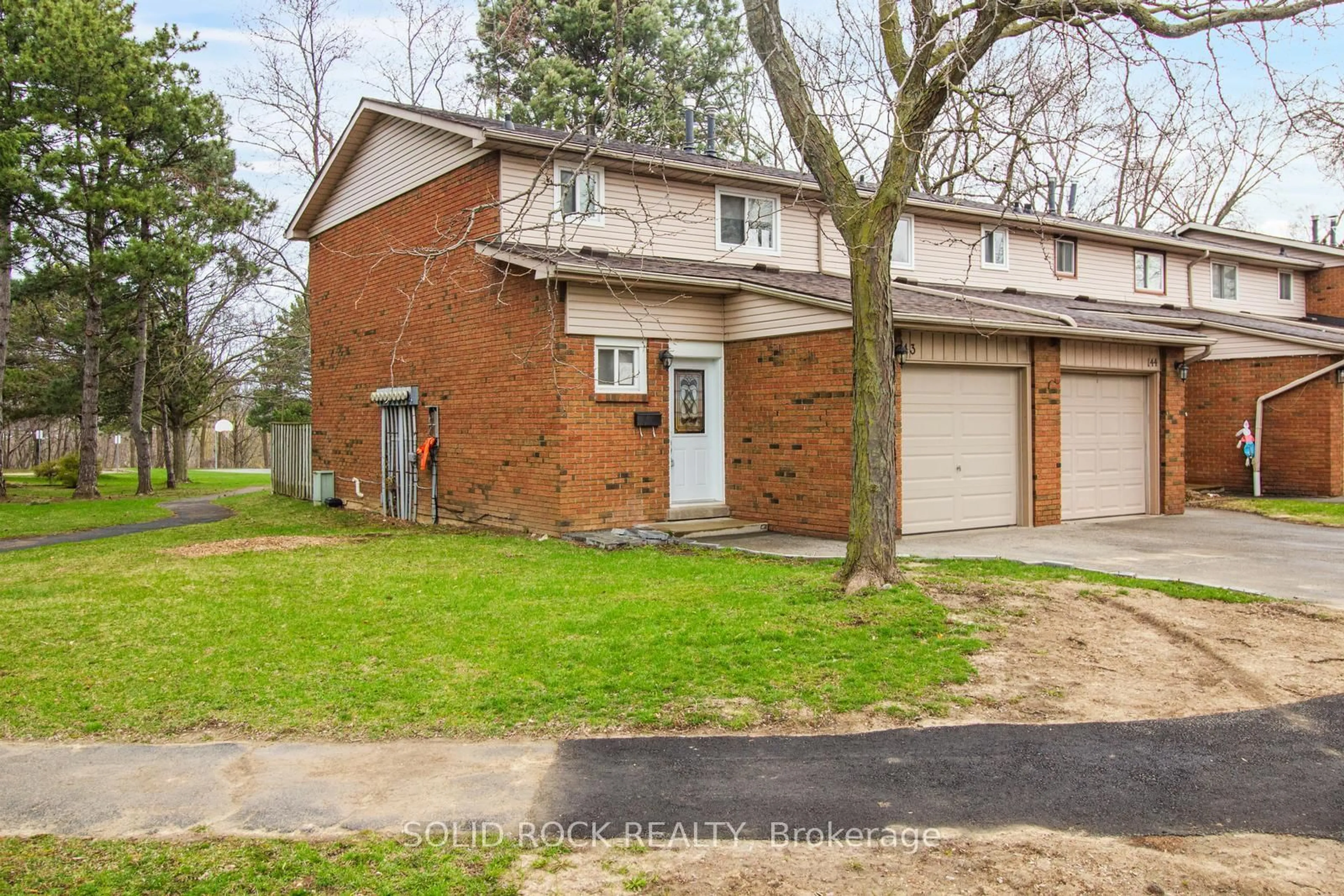 Home with brick exterior material, street for 100 Quigley Rd #143, Hamilton Ontario L8K 6J1
