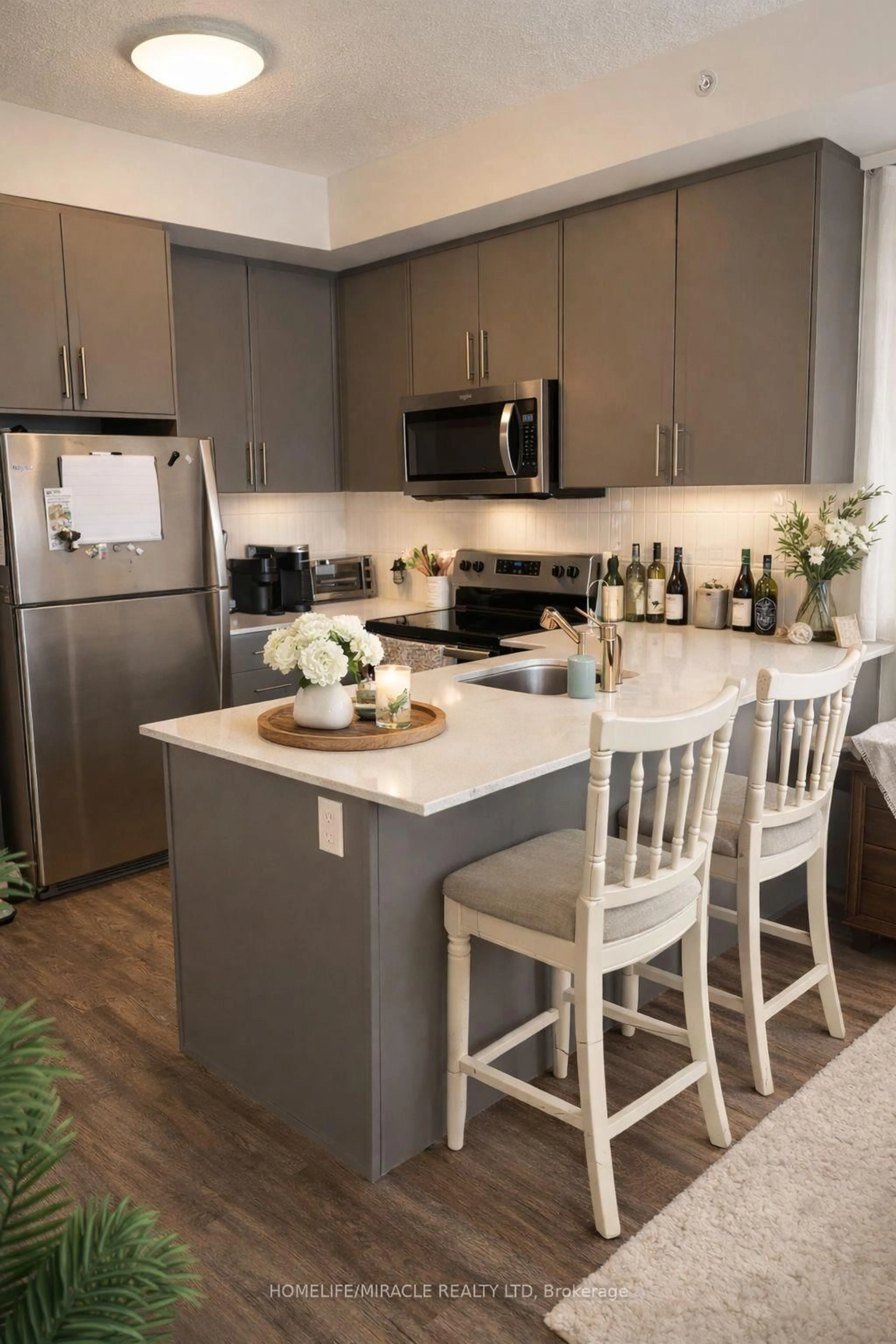 Open concept kitchen, wood/laminate floor for 107 Roger St #410, Waterloo Ontario N2J 0G3