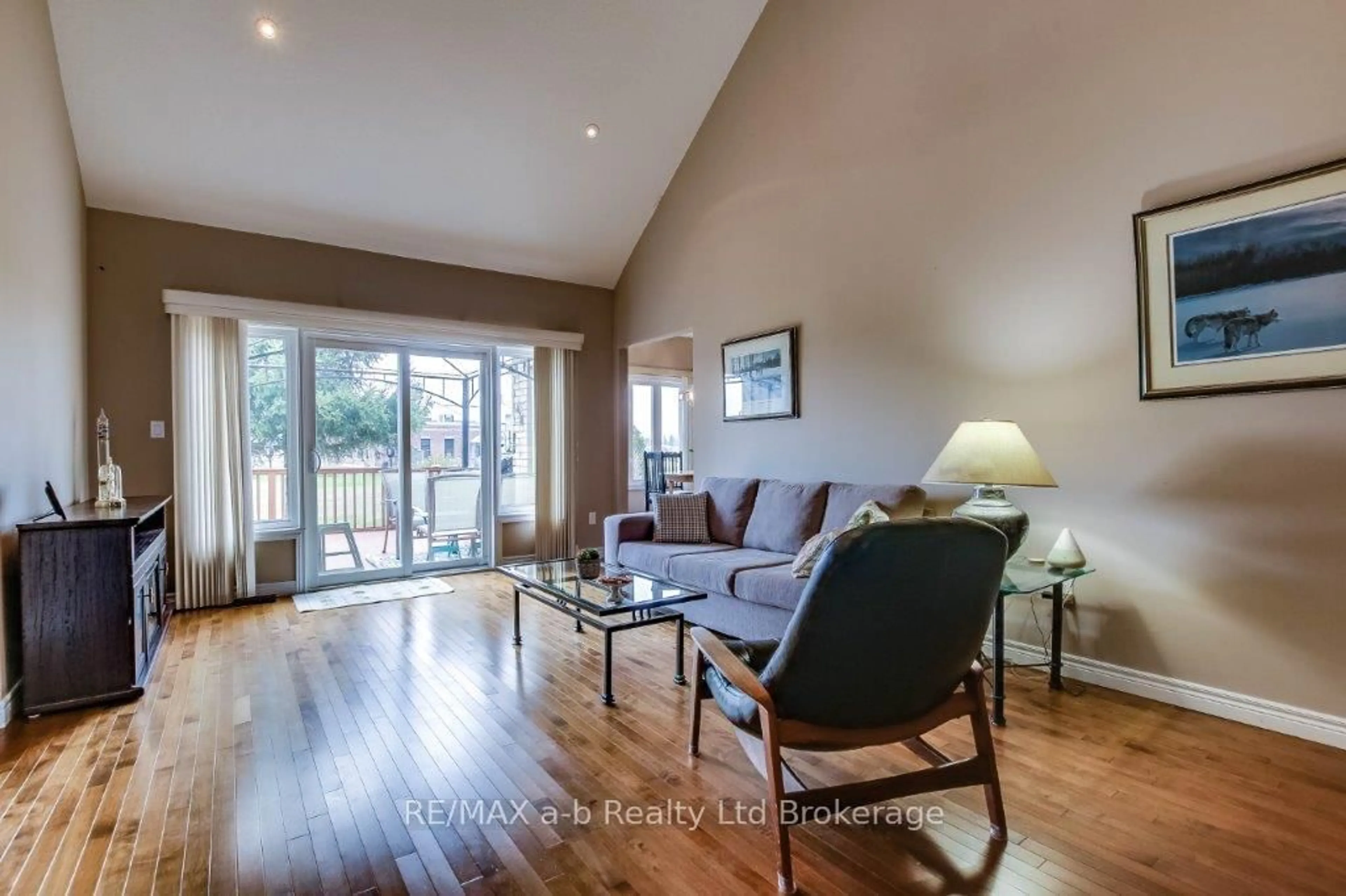 Living room with furniture, wood/laminate floor for 717 Garden Court Cres, Woodstock Ontario N4T 0A2