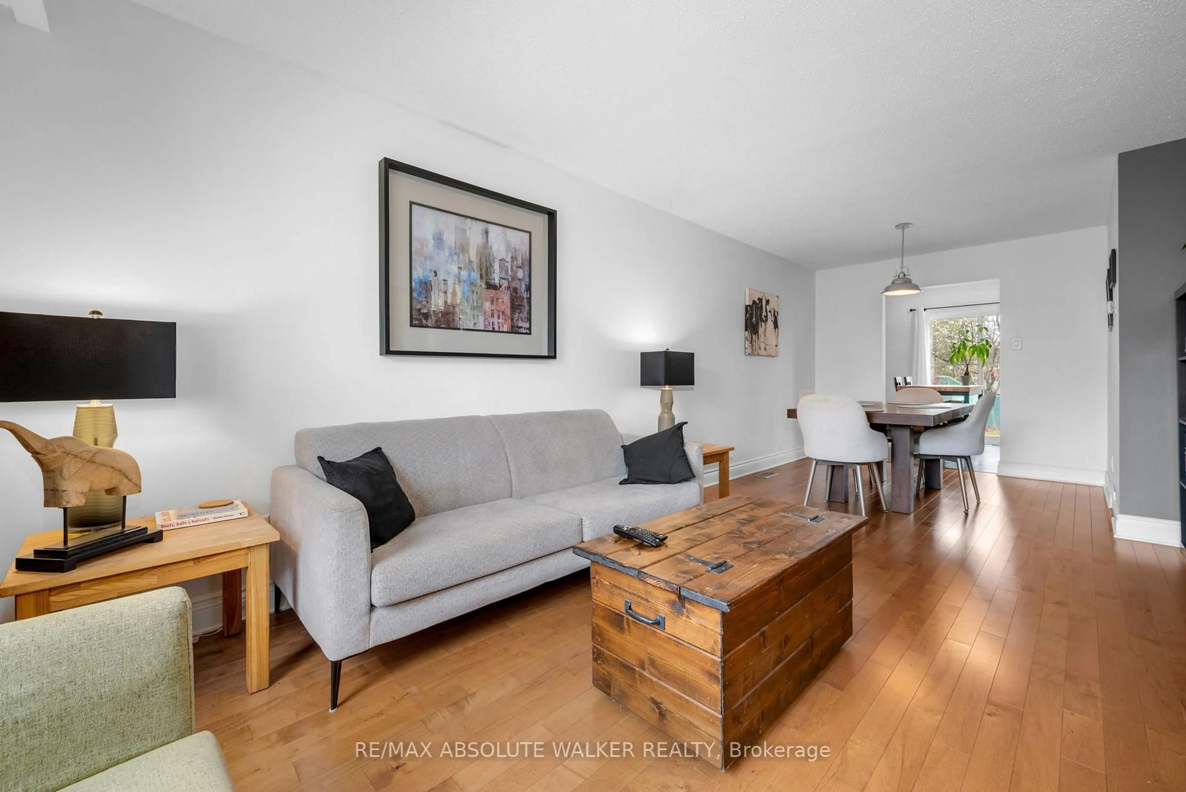 Living room with furniture, wood/laminate floor for 6289 Vorlage Dr, Ottawa Ontario K1C 2E4