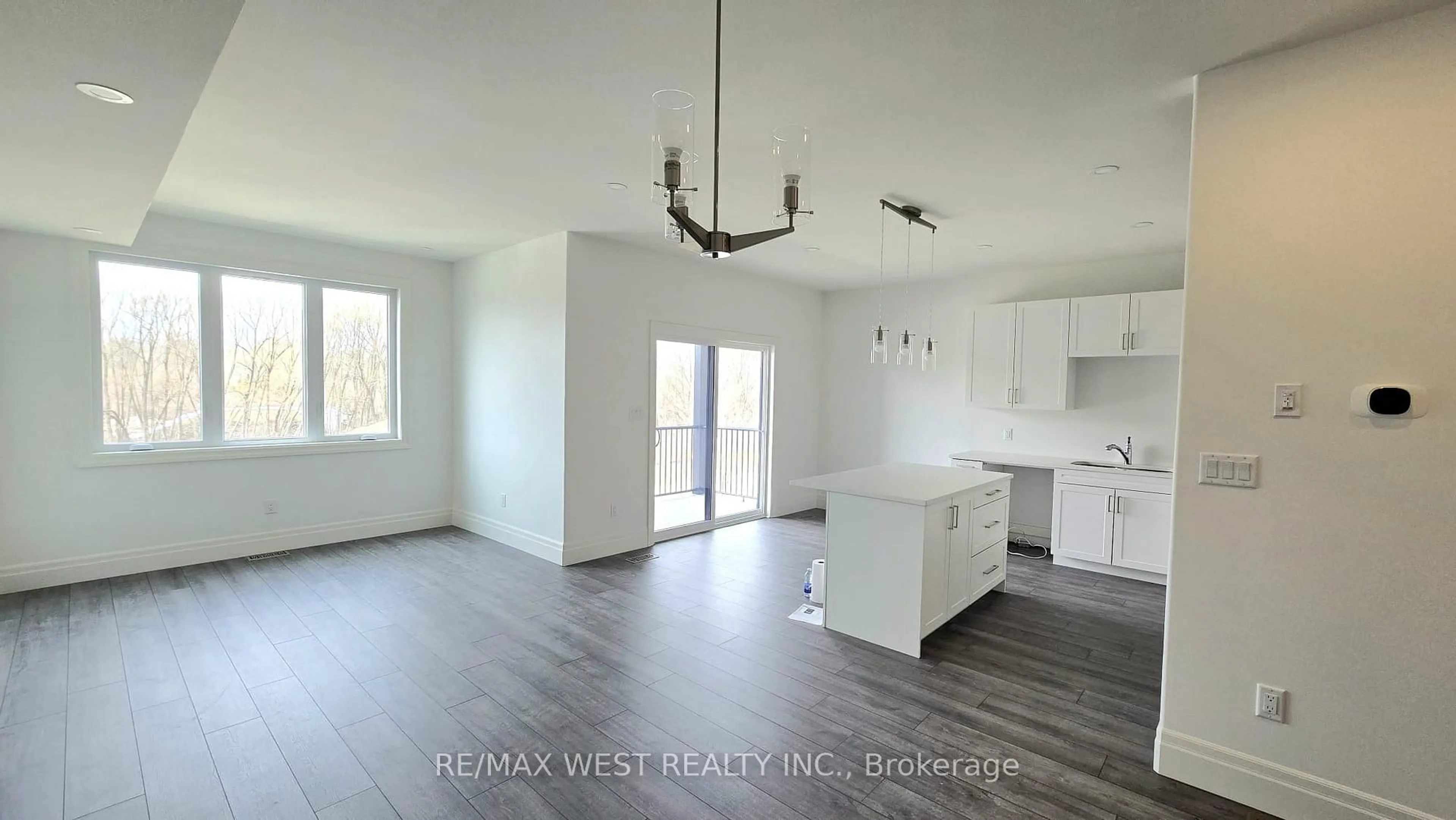 Open concept kitchen, wood/laminate floor for 97 Buchanan Ave, Prince Edward County Ontario K0K 2T0