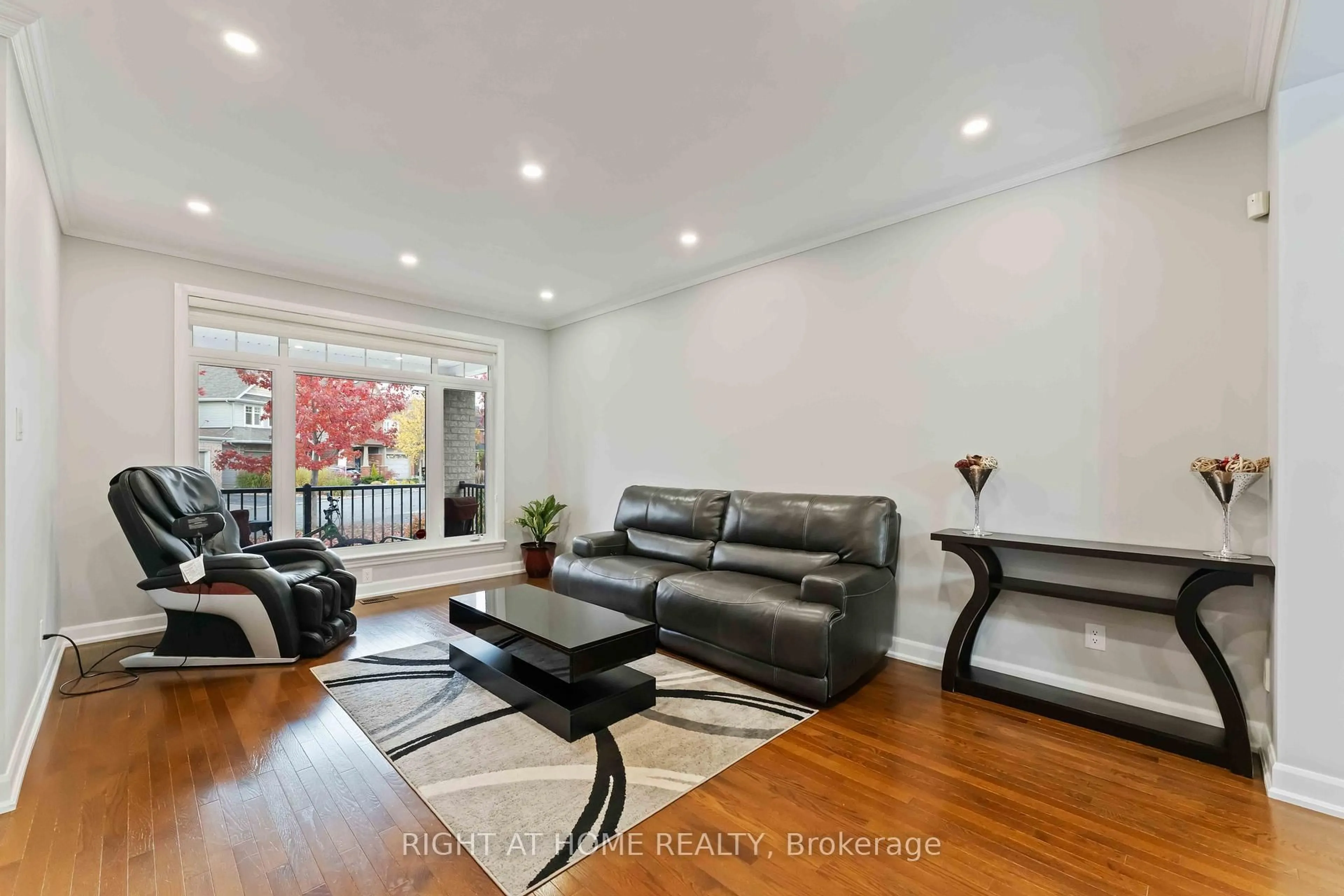 Living room with furniture, wood/laminate floor for 211 Denali Way, Stittsville Ontario K2S 0N1