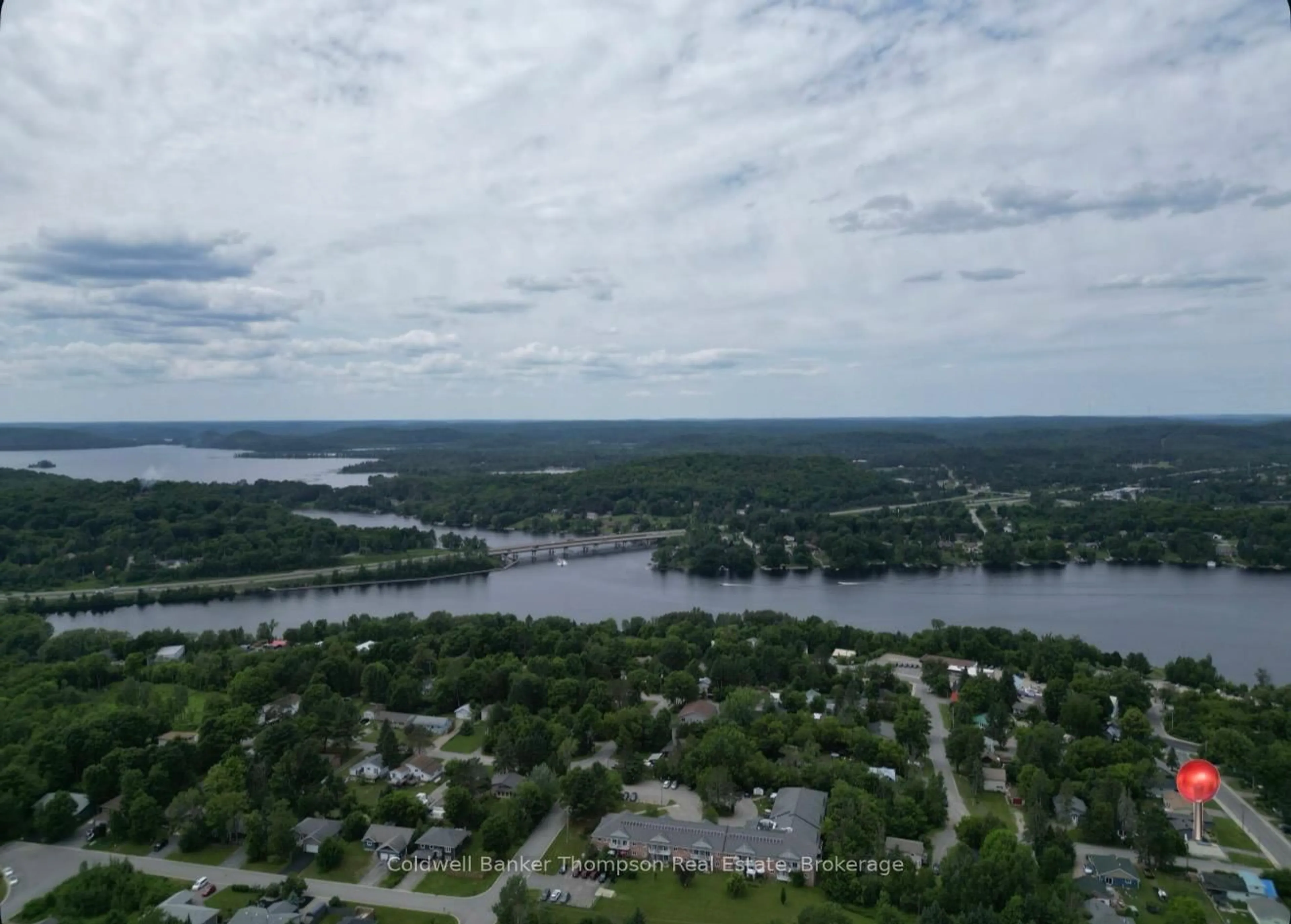 A pic from outside/outdoor area/front of a property/back of a property/a pic from drone, water/lake/river/ocean view for 13 Yonge St, Huntsville Ontario P1H 1W7