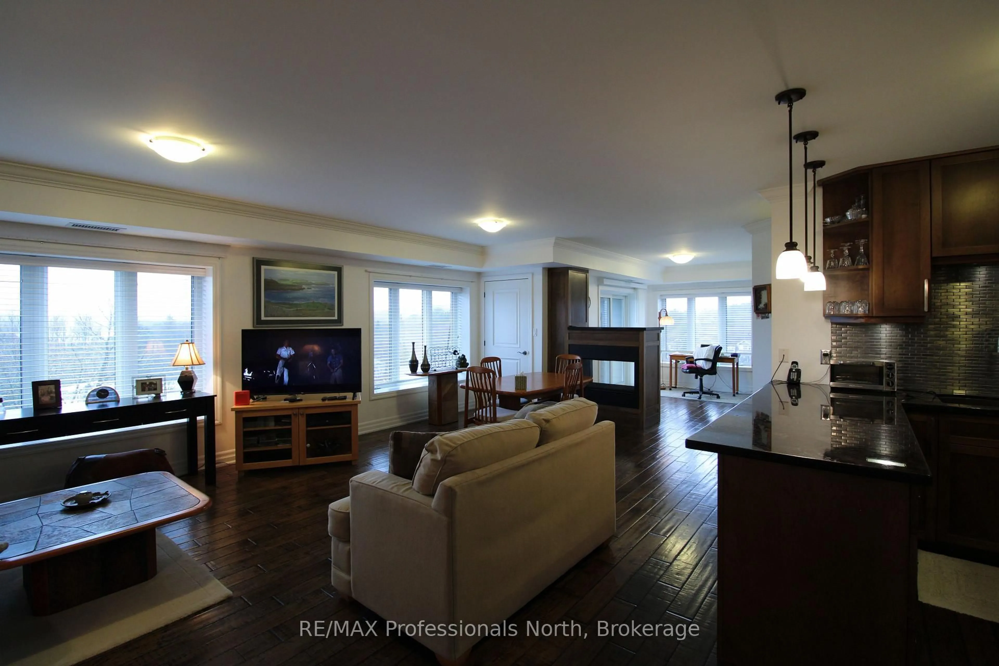 Living room with furniture, wood/laminate floor for 26 Dairy Lane #402, Huntsville Ontario P1H 0A4