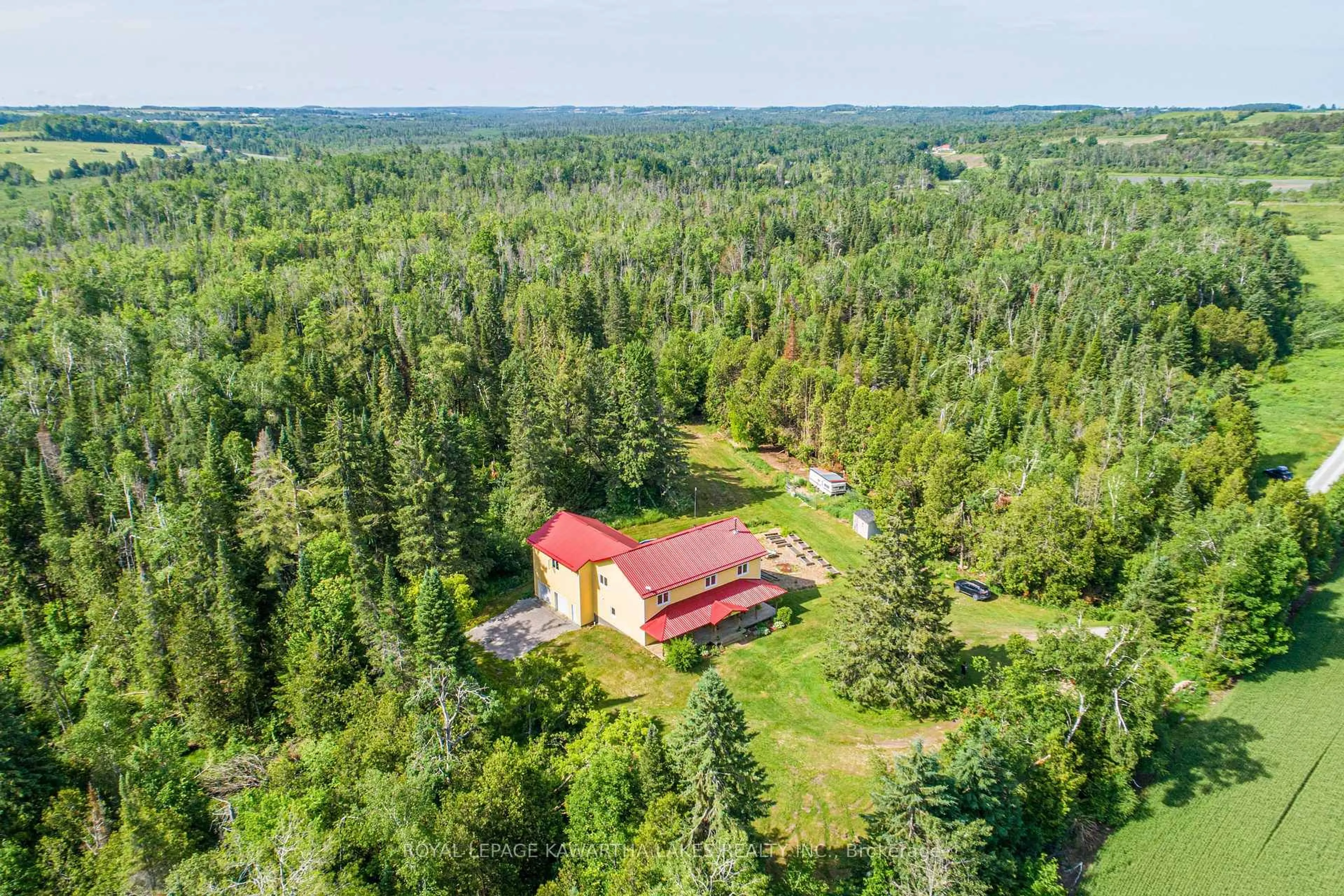 A pic from outside/outdoor area/front of a property/back of a property/a pic from drone, forest/trees view for 1752 Highway 35, Kawartha Lakes Ontario L0B 1K0