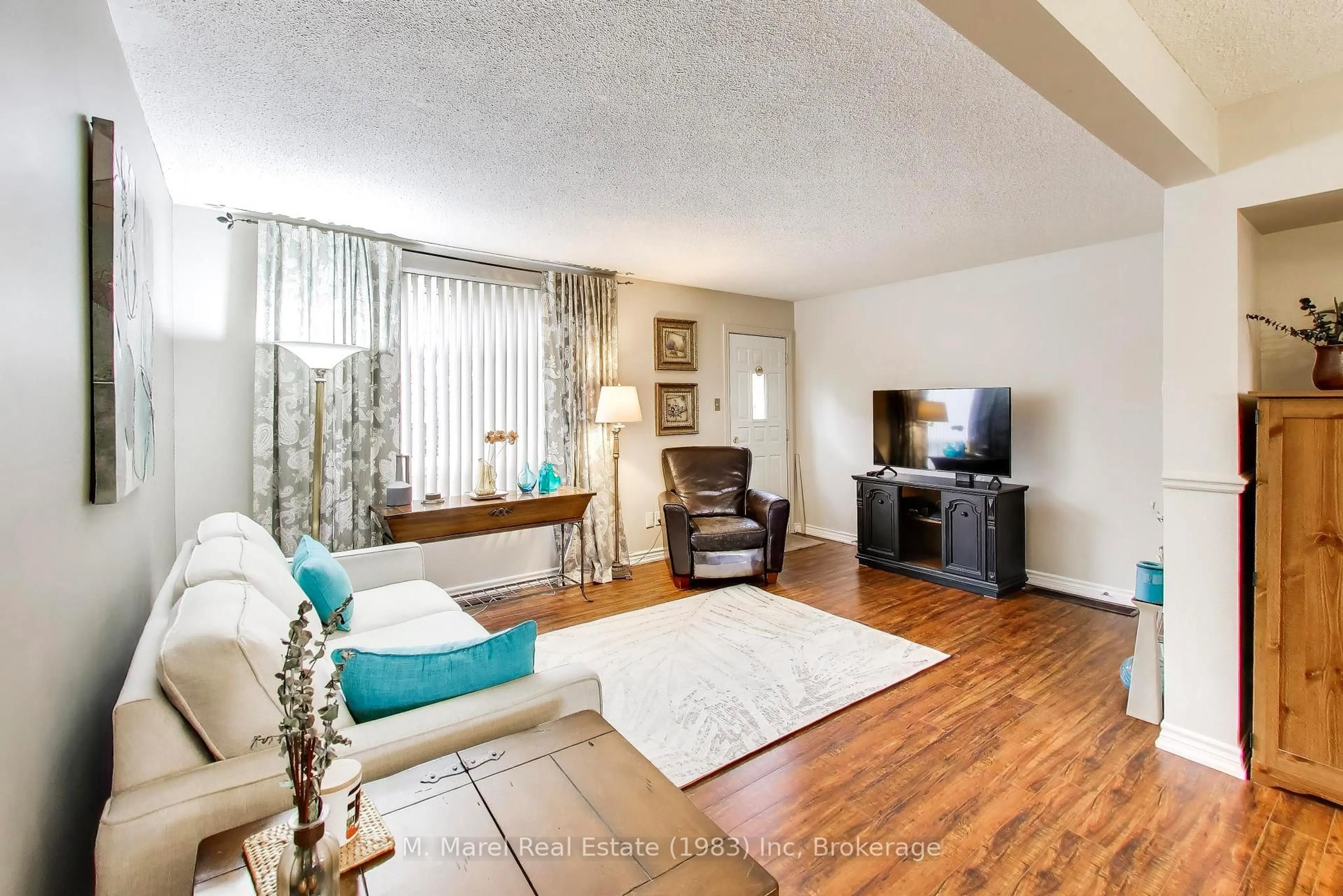 Living room with furniture, wood/laminate floor for 250 Magnolia Dr #57, Hamilton Ontario L9C 6M3