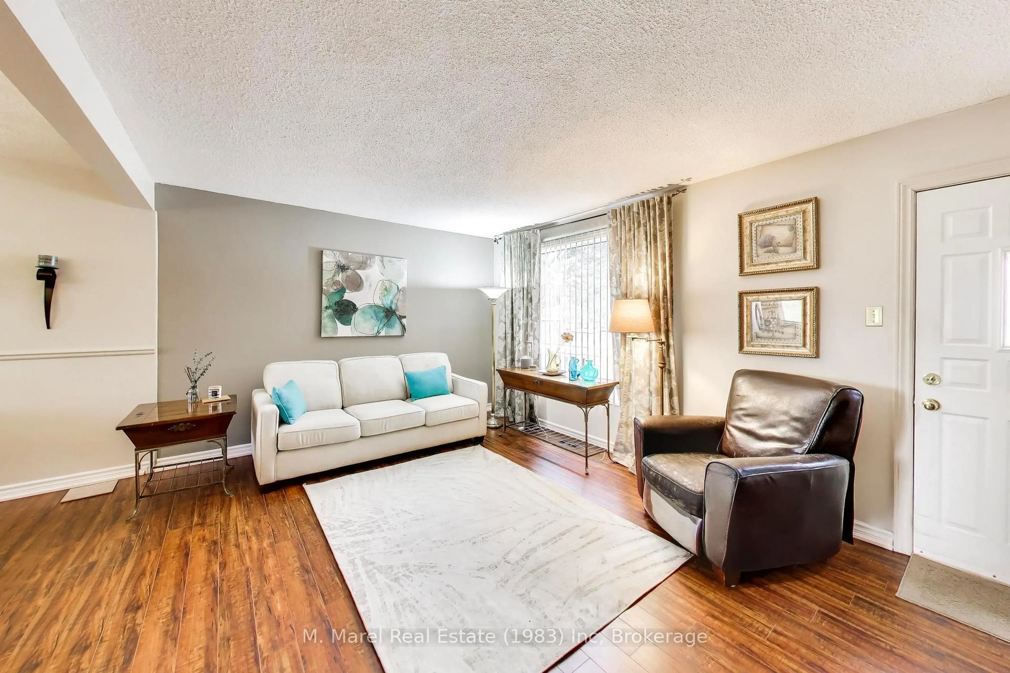 Living room with furniture, wood/laminate floor for 250 Magnolia Dr #57, Hamilton Ontario L9C 6M3