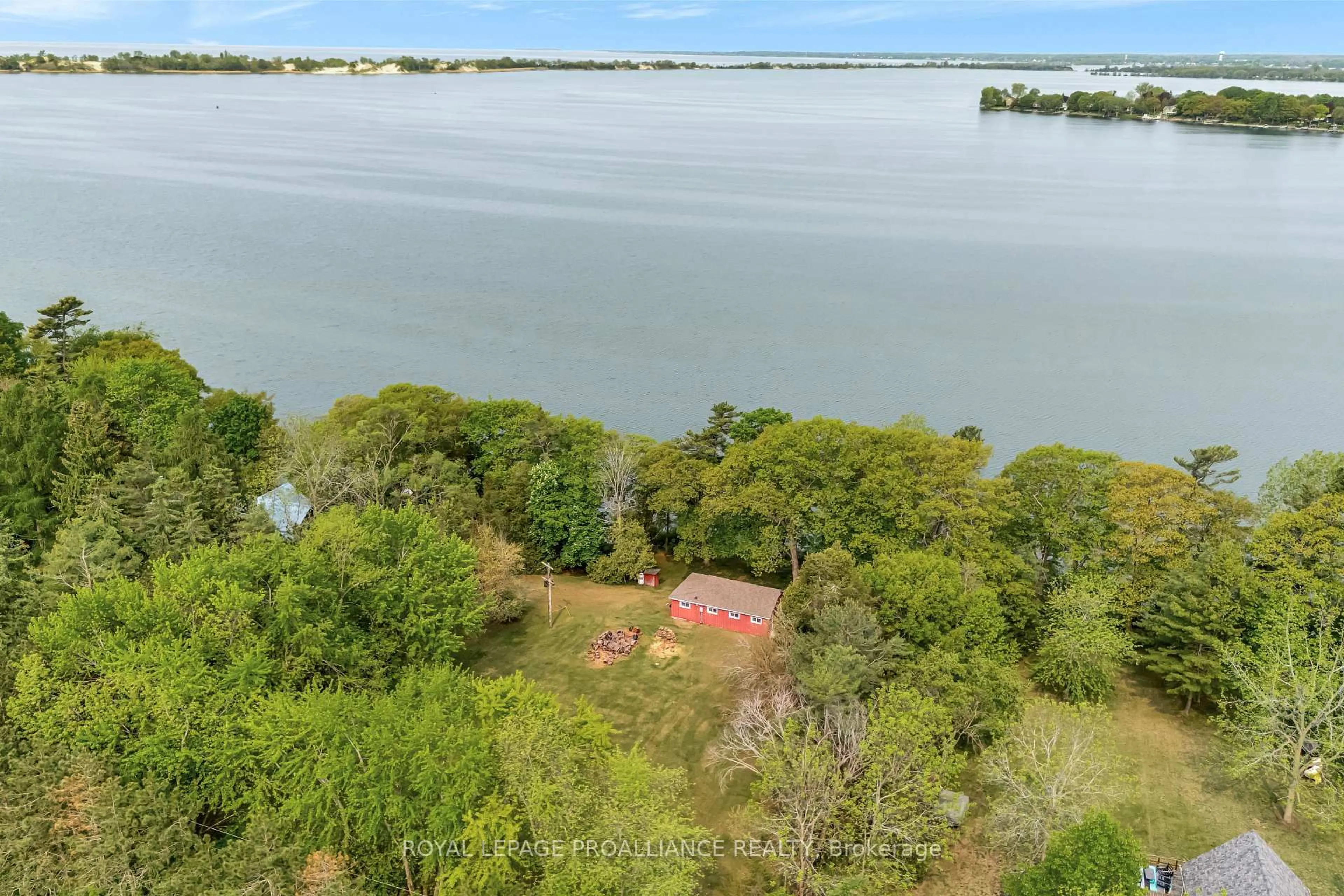 A pic from outside/outdoor area/front of a property/back of a property/a pic from drone, water/lake/river/ocean view for 27 Thrush Lane, Prince Edward County Ontario K0K 2T0