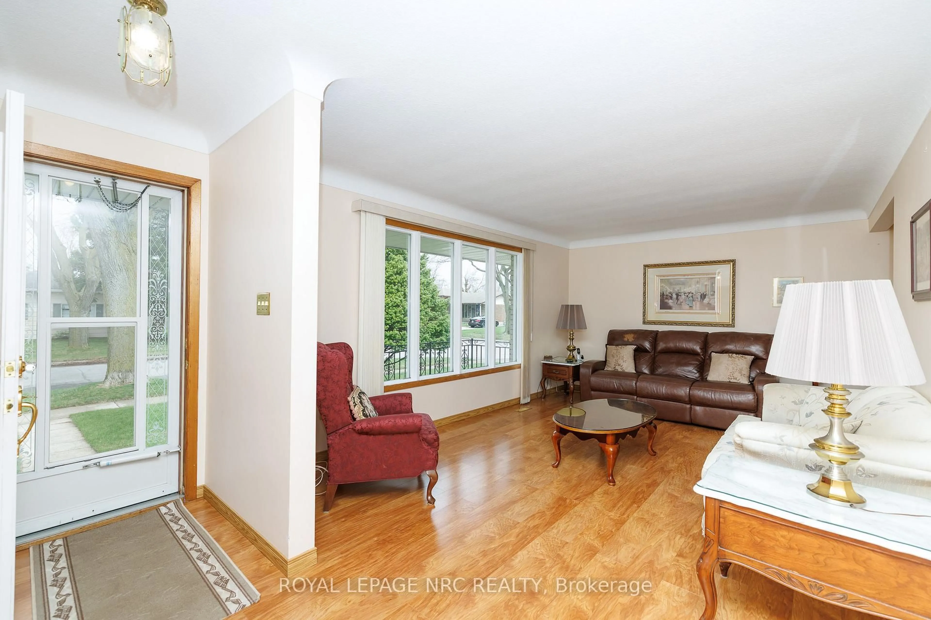 Living room with furniture, wood/laminate floor for 6536 Cropp St, Niagara Falls Ontario L2E 5J7