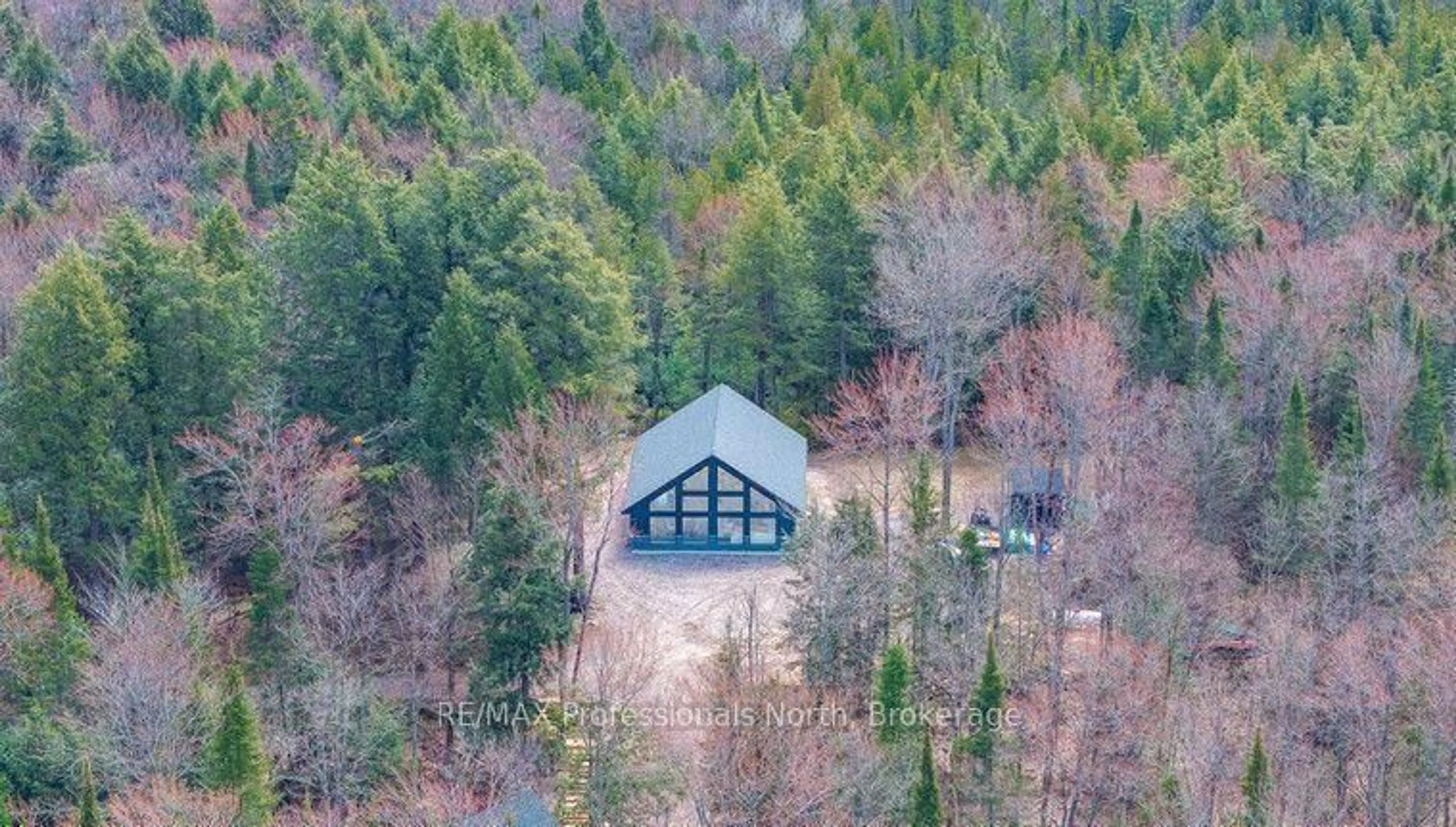 A pic from outside/outdoor area/front of a property/back of a property/a pic from drone, forest/trees view for 1820 Riding Ranch Rd, Machar Ontario P0A 1X0