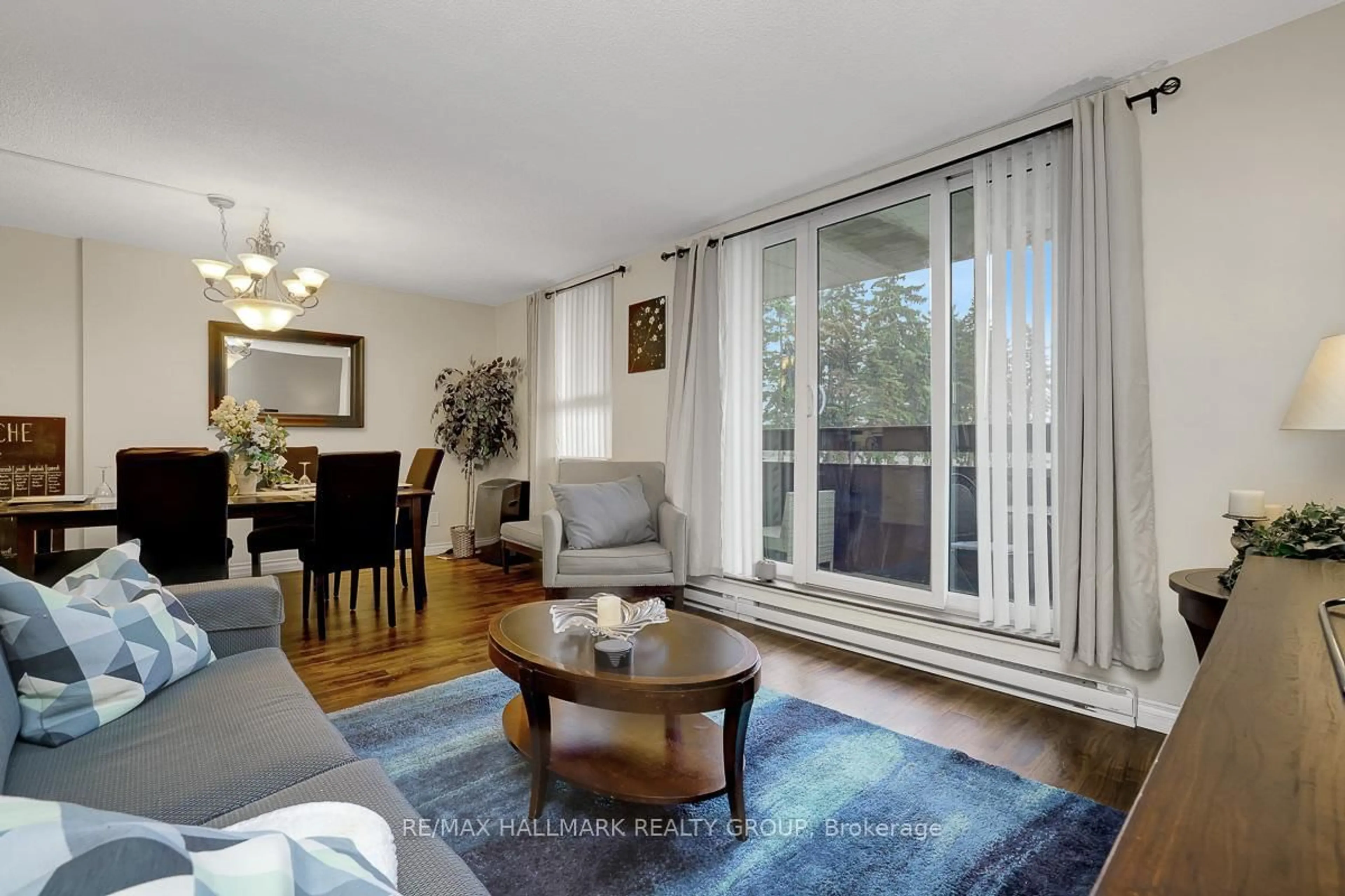 Living room with furniture, wood/laminate floor for 2000 Jasmine Cres #210, Ottawa Ontario K1J 8K4