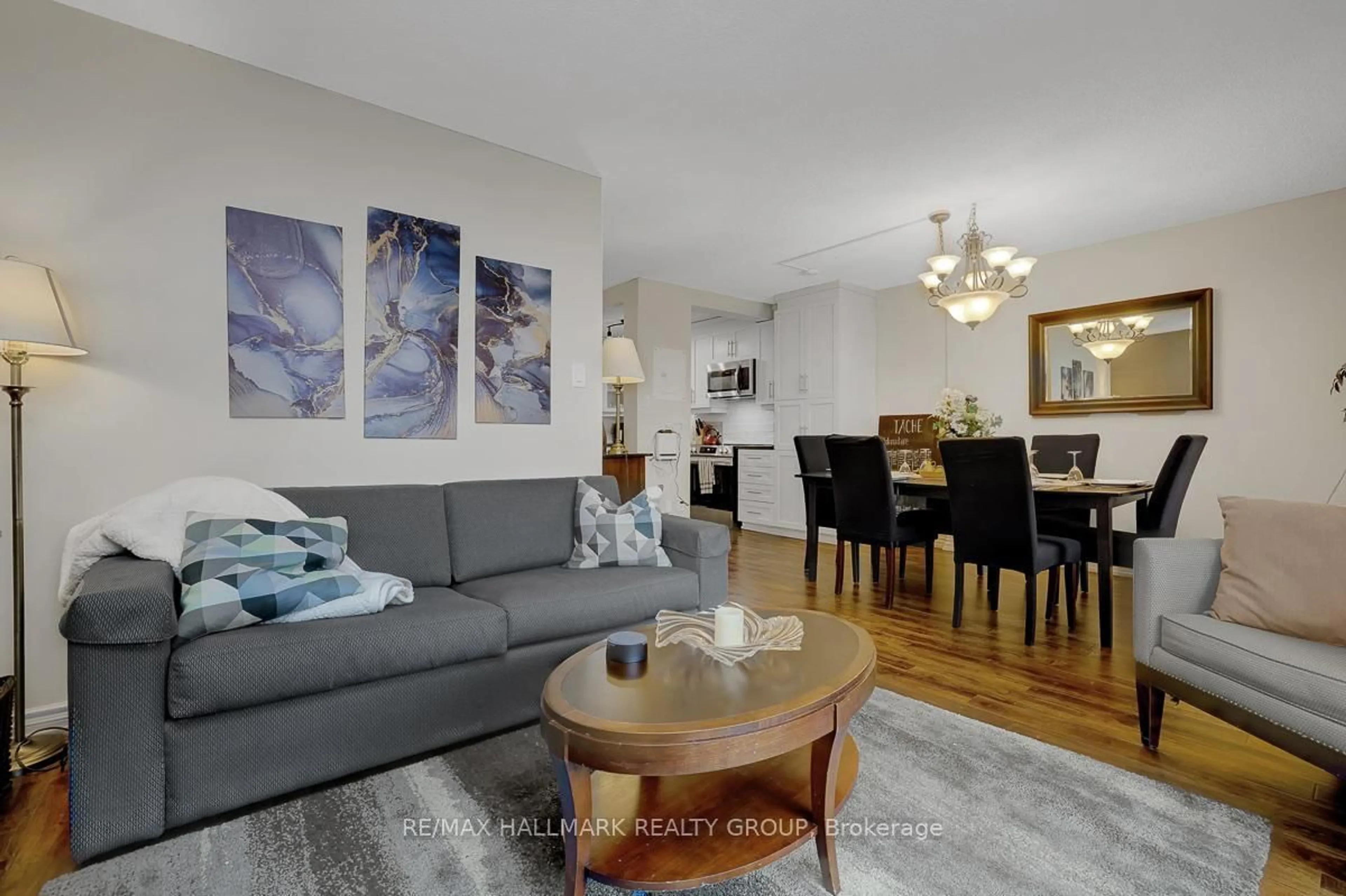 Living room with furniture, wood/laminate floor for 2000 Jasmine Cres #210, Ottawa Ontario K1J 8K4